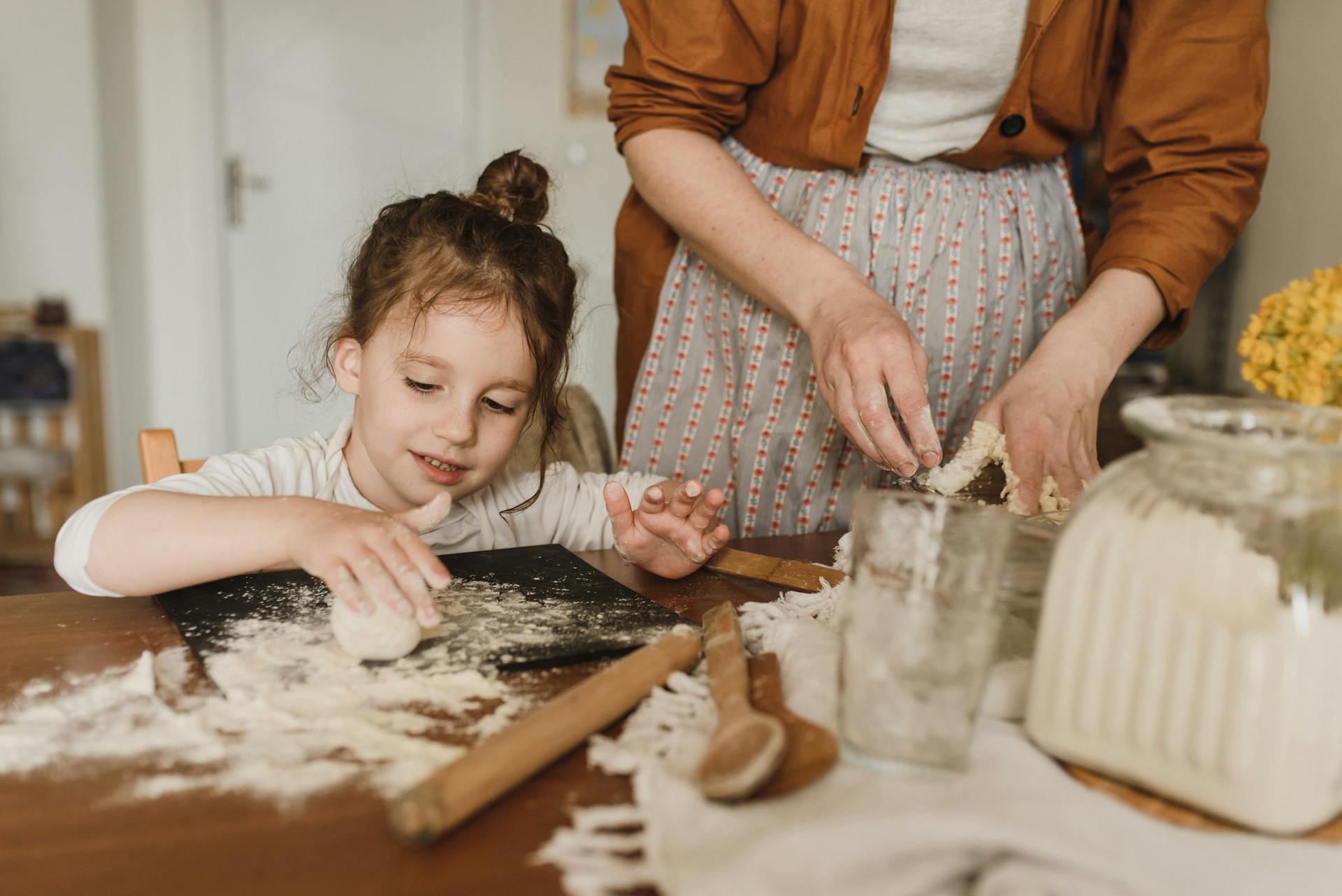 A girl helping her grandmother bake | Source: Pexels