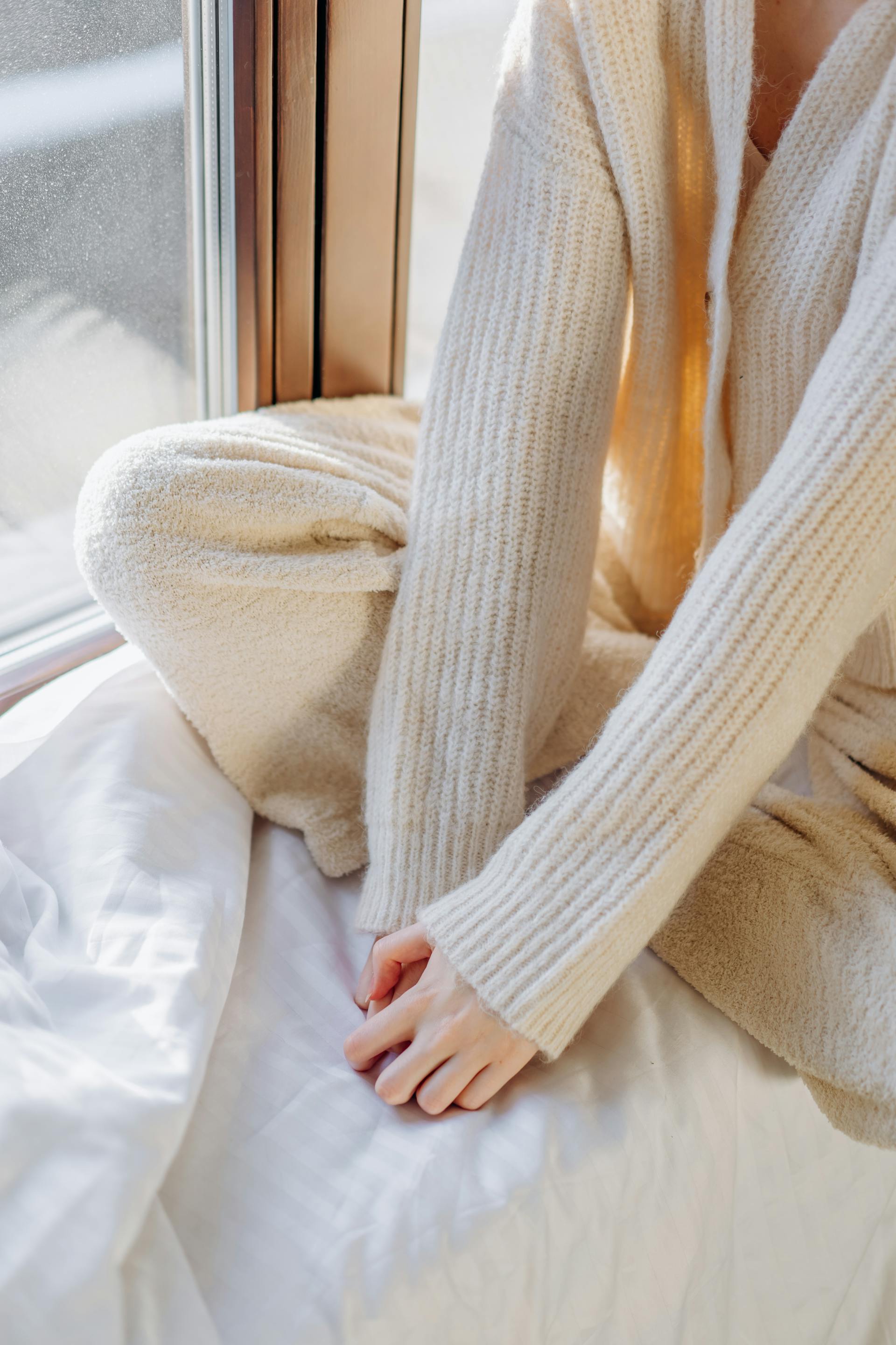A close-up shot of a woman sitting by the window | Source: Pexels