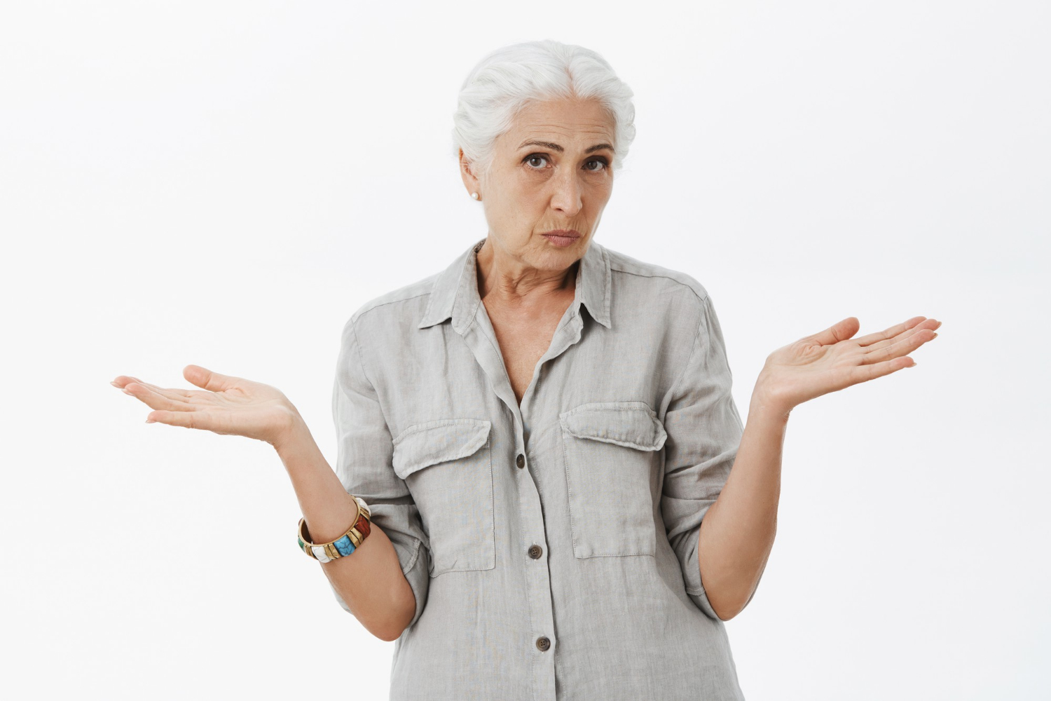 An older woman shrugging | Source: Freepik
