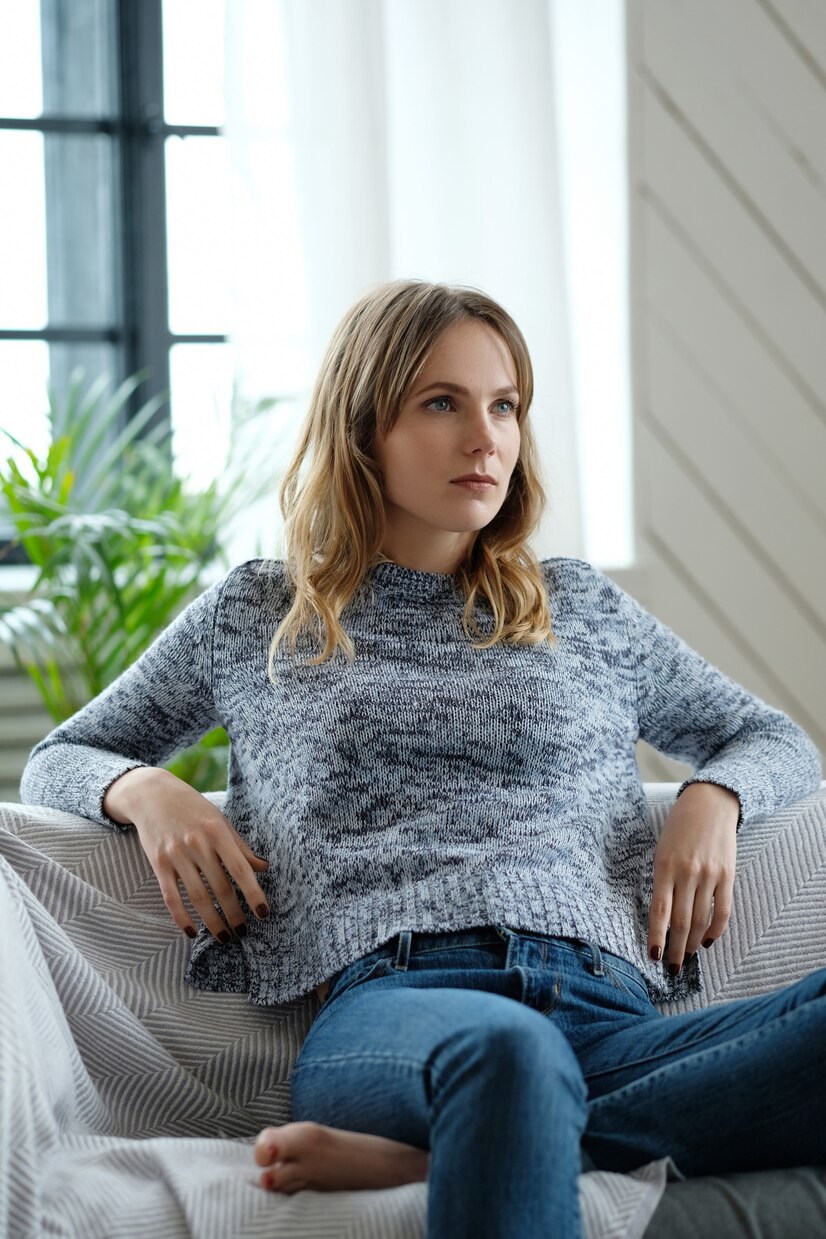 A confident woman on her couch | Source: Freepik