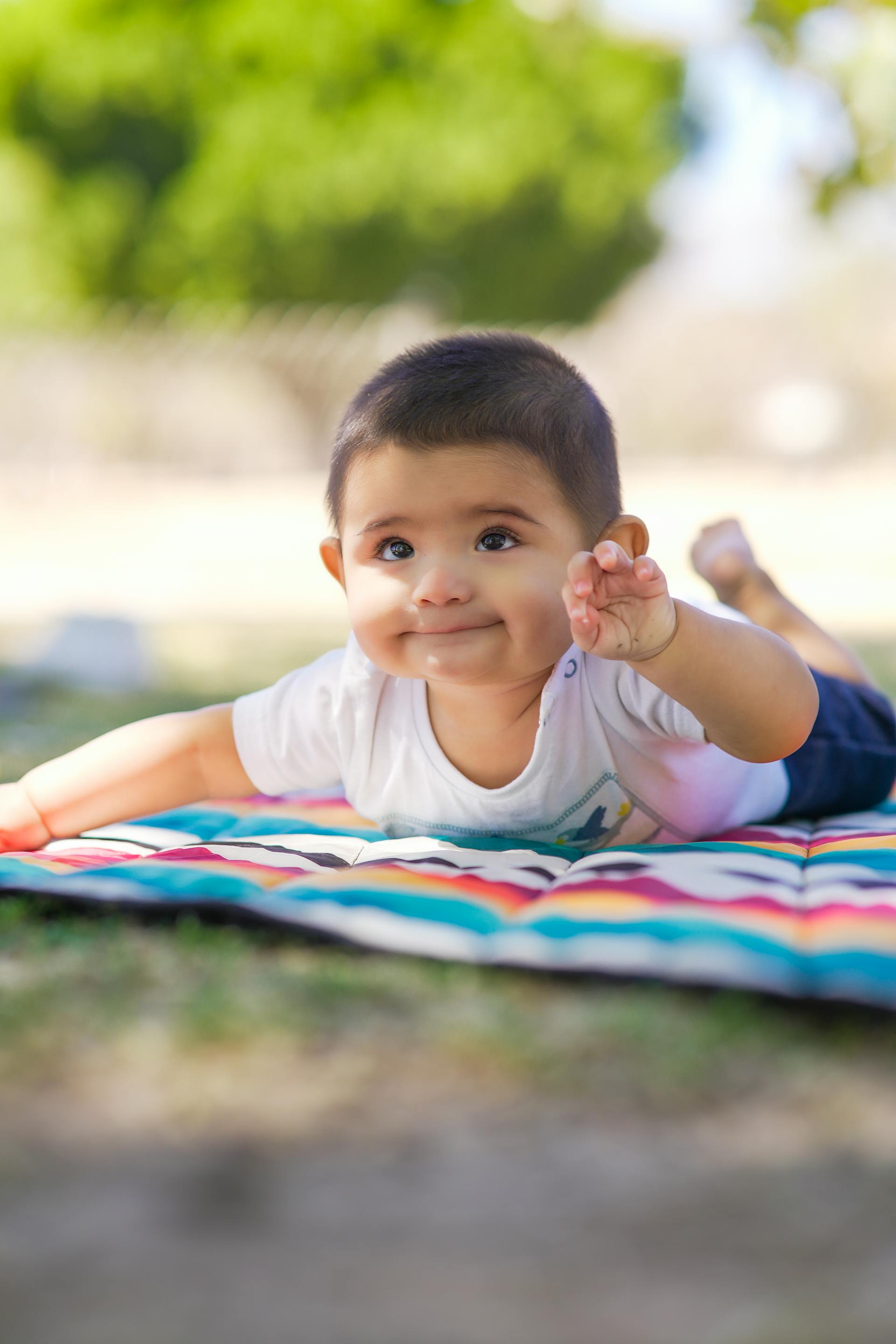 A cute baby lying on a blanket | Source: Pexels