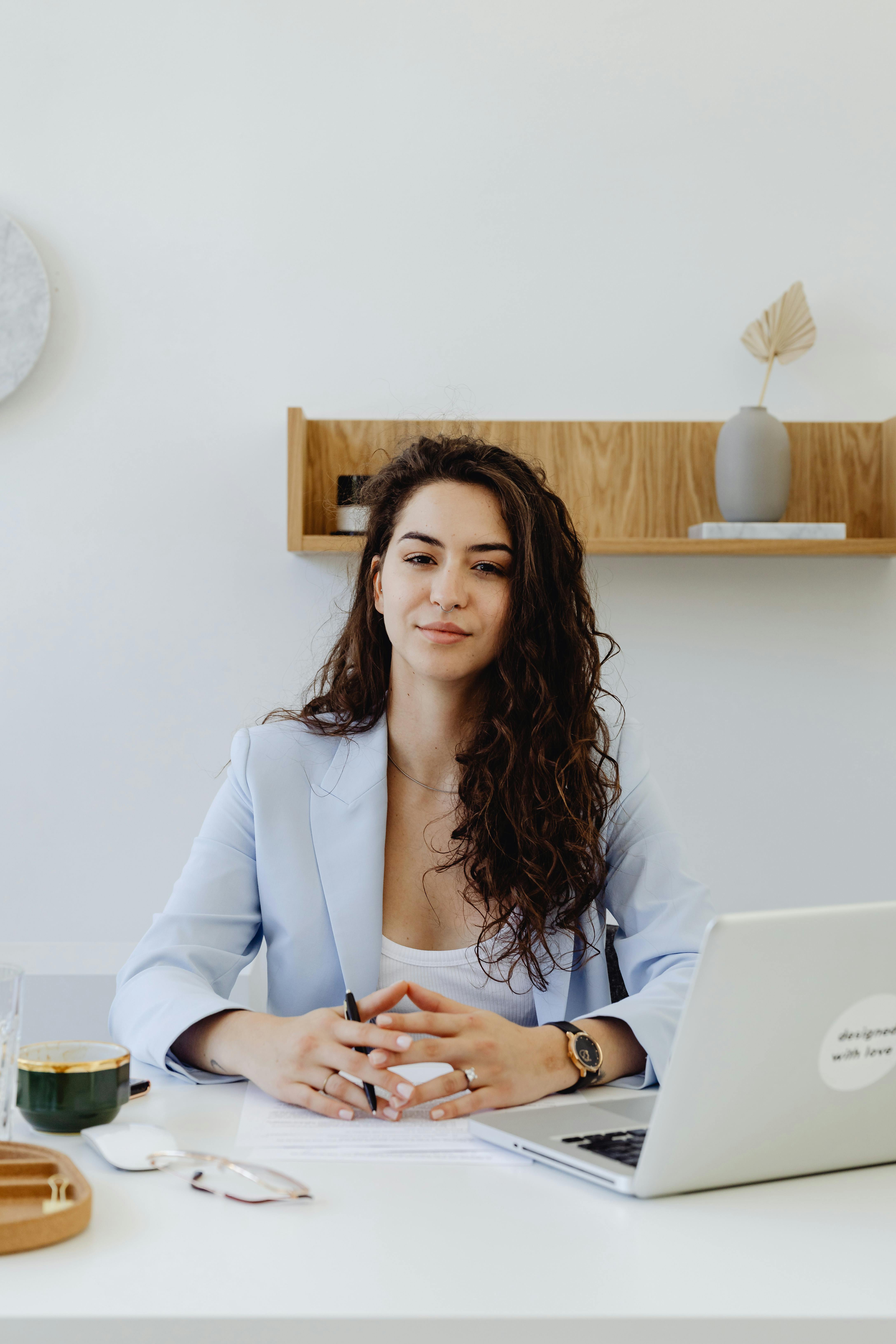 A woman sitting in her office | Source: Pexels