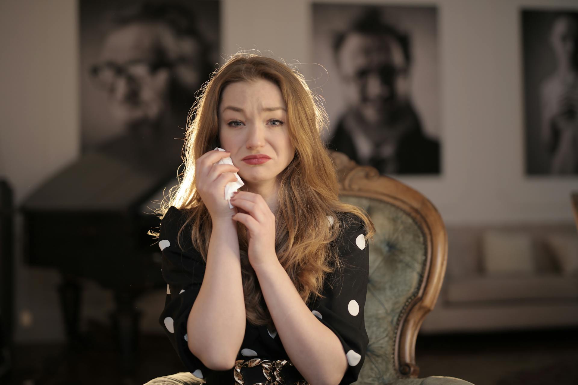 A sad woman in a black and white polka-dot dress | Source: Pexels