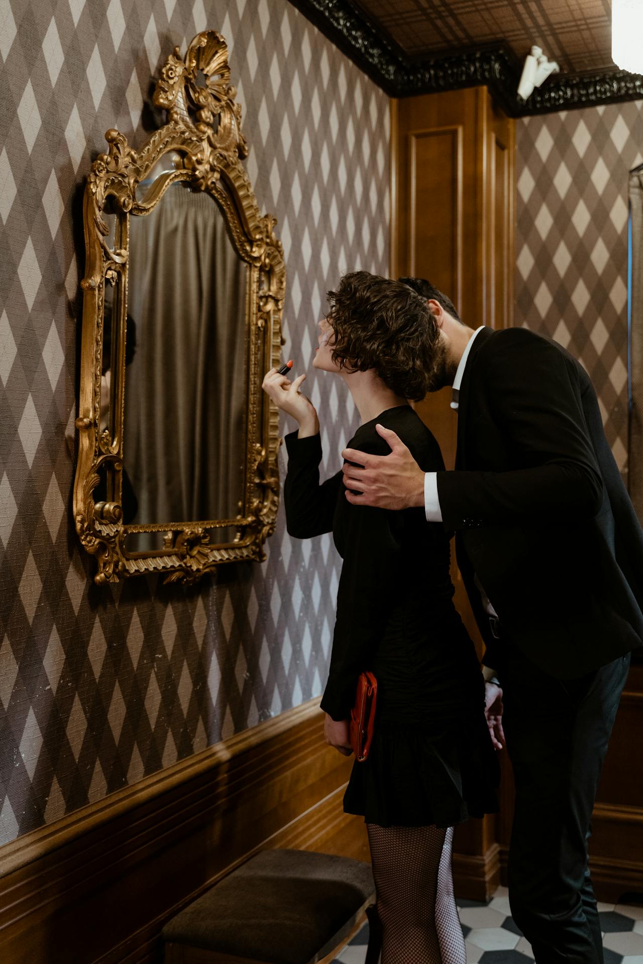 A woman looking at the mirror while her partner embraces her | Source: Pexels