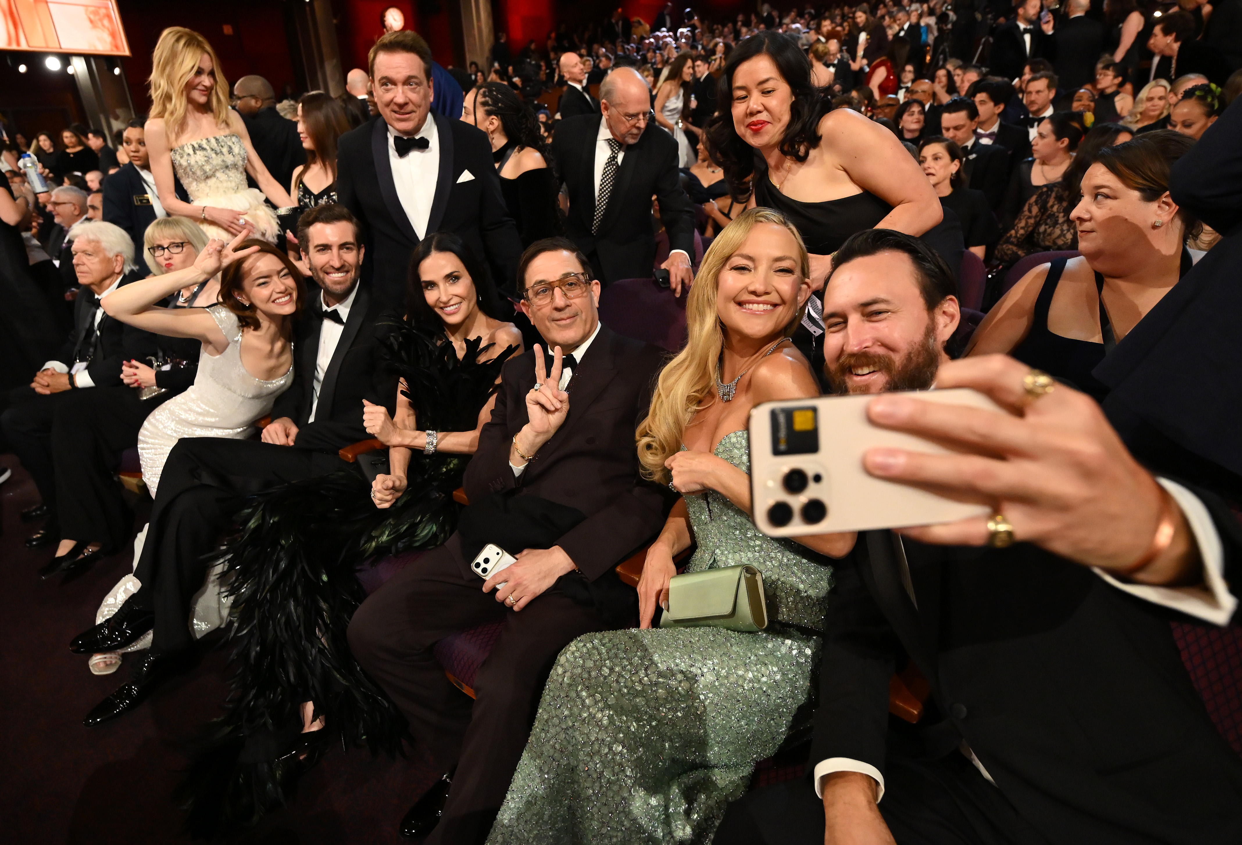 Emma Stone, Dave McCary, Demi Moore, Kate Hudson and Danny Fujikawa pose for a selfie in the crowd during the 98th Oscards at Dolby Theatre on March 15, 2026 in Hollywood, California. | Source: Getty Images
