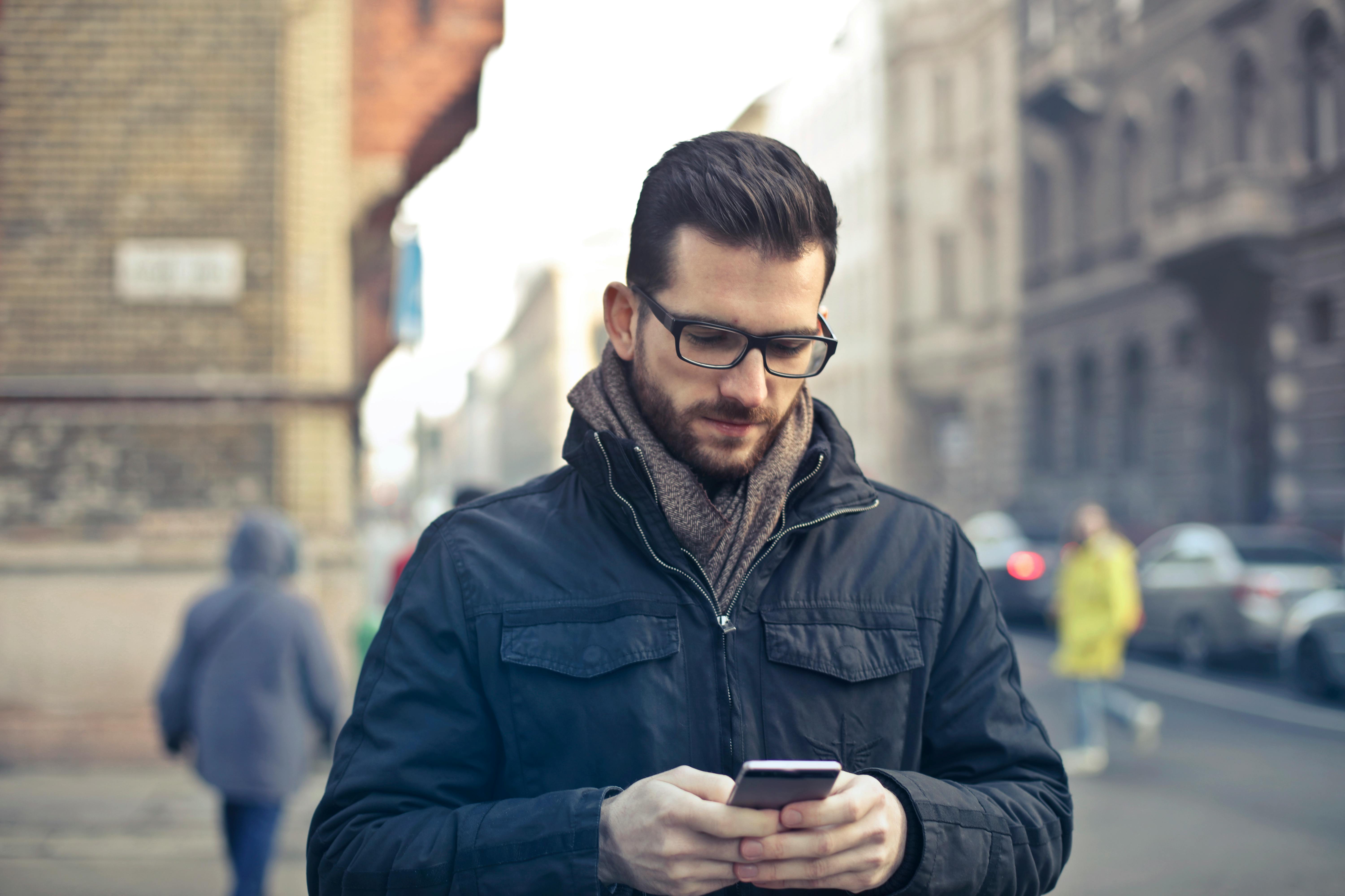 A serious man looking at his phone | Source: Pexels