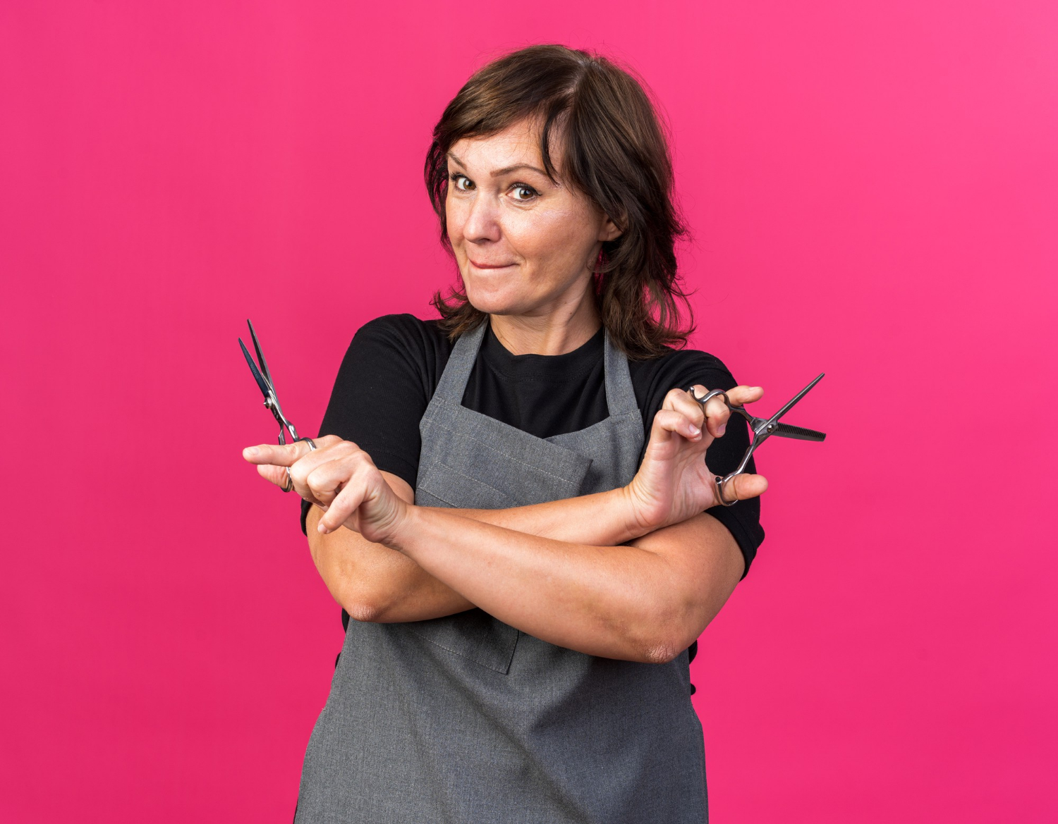 A delighted hairdresser holding scissors | Source: Freepik
