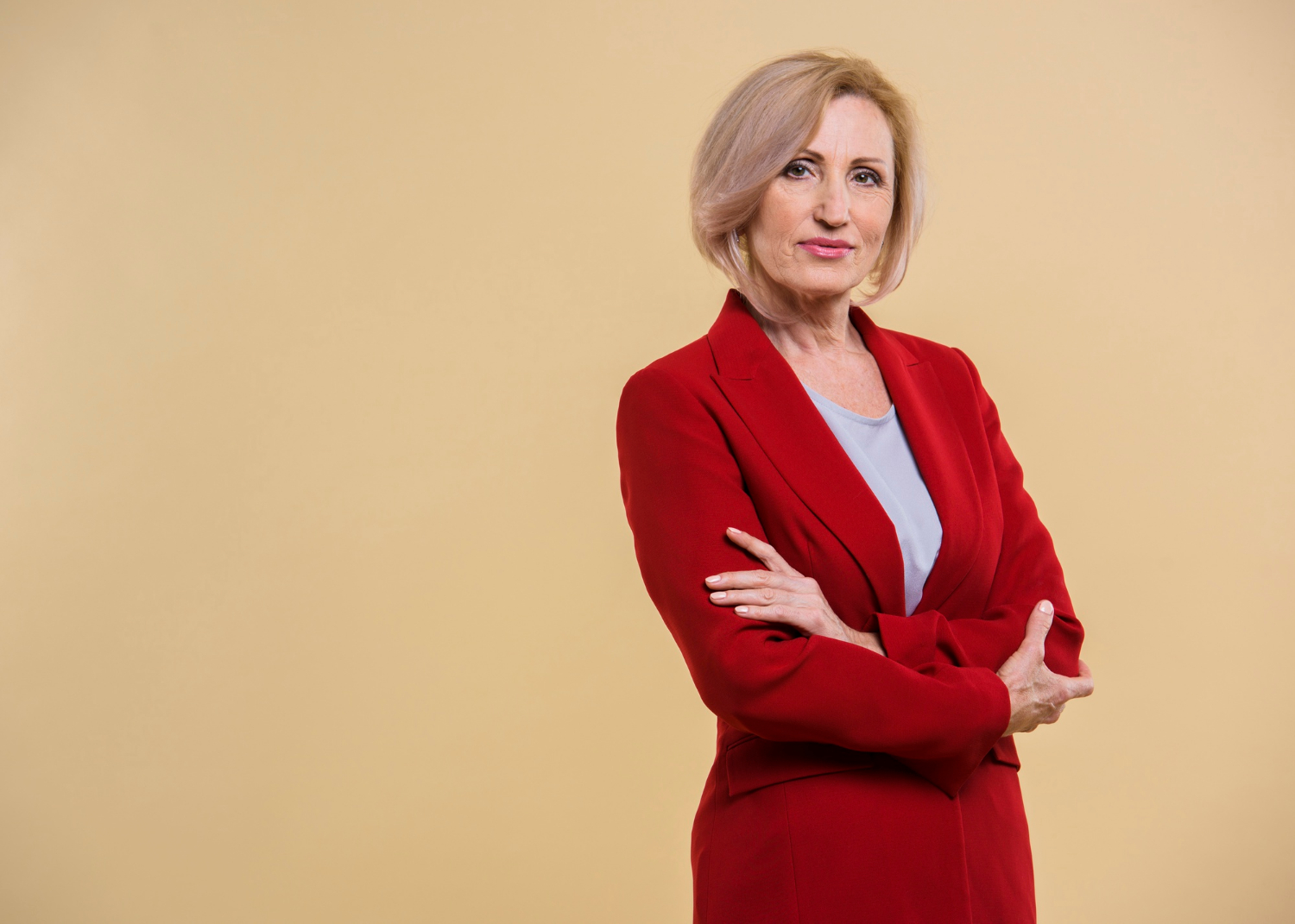 A senior woman with her arms crossed | Source: Freepik