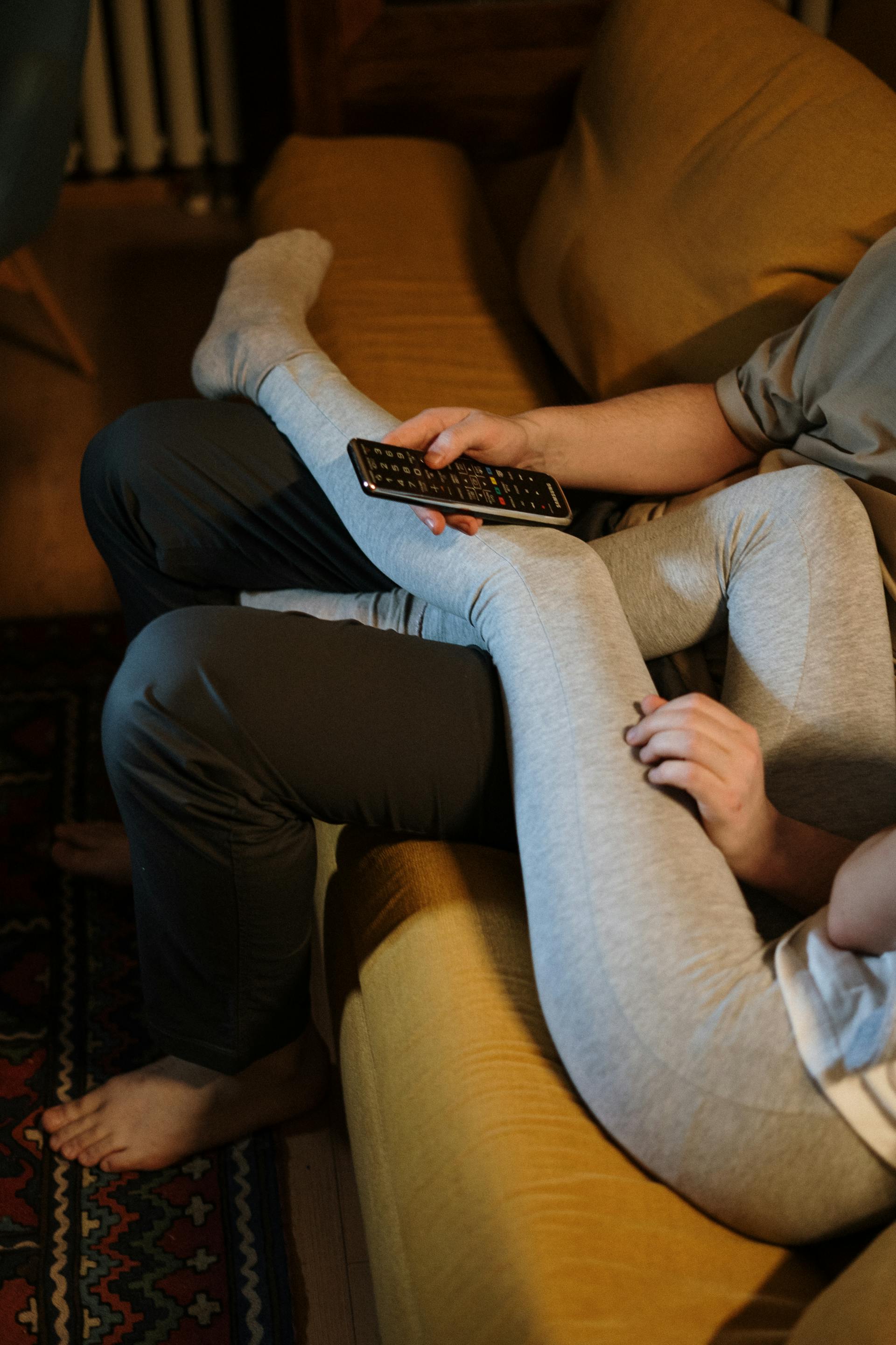 A couple relaxing on a sofa | Source: Pexels