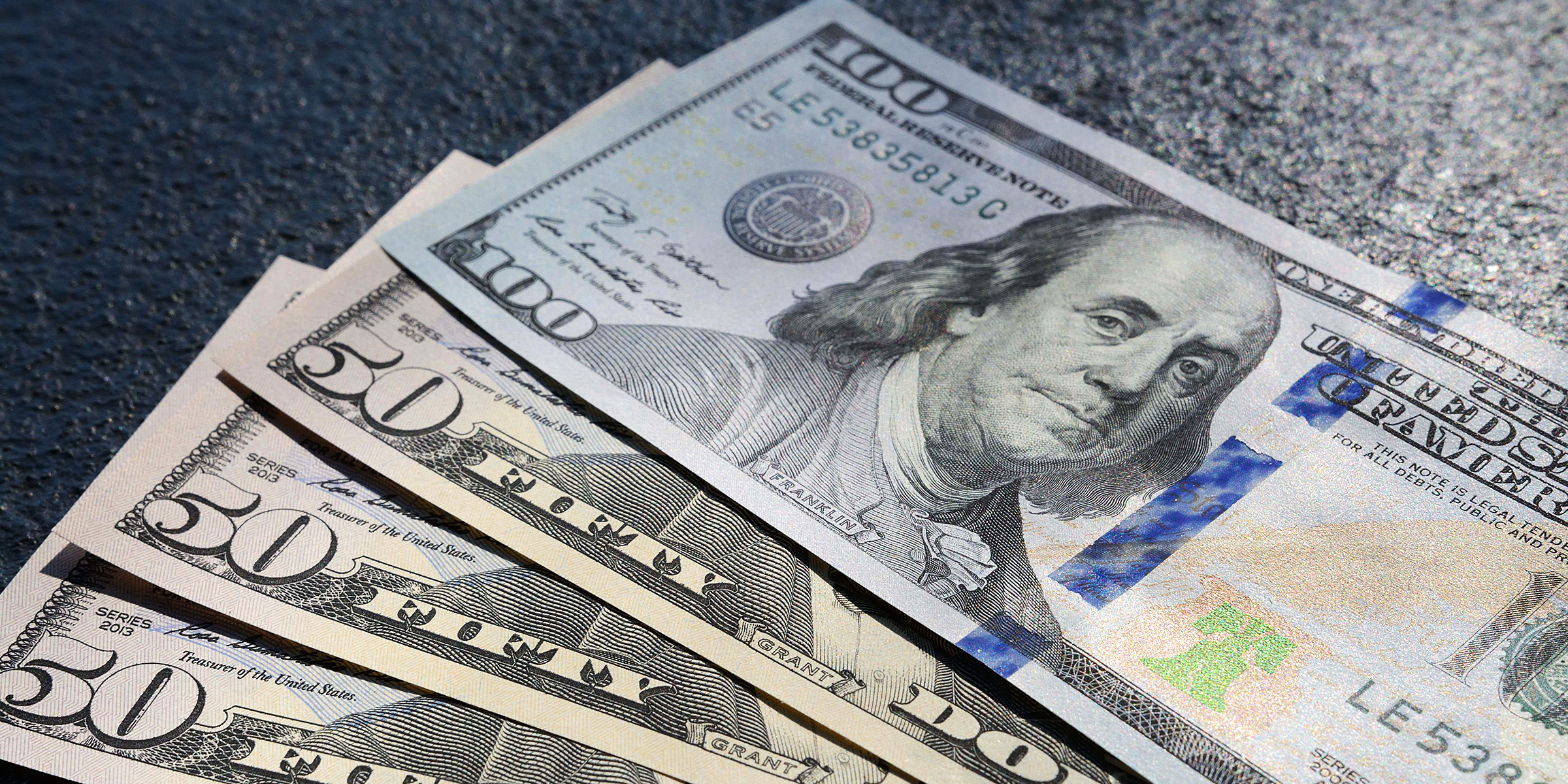 Dollar bills on a surface | Source: Freepik