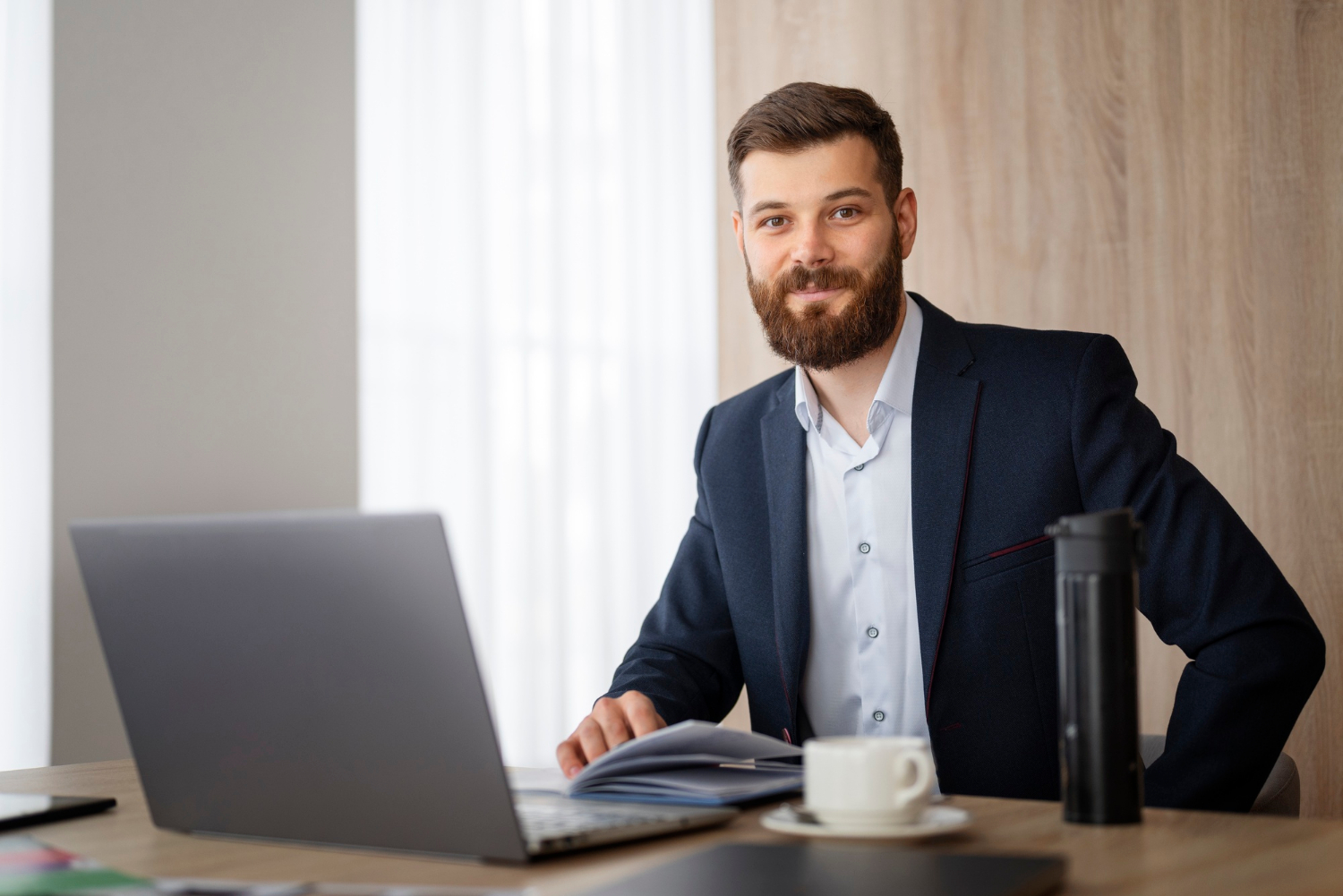 An elegant businessman sitting in his office | Source: Freepik