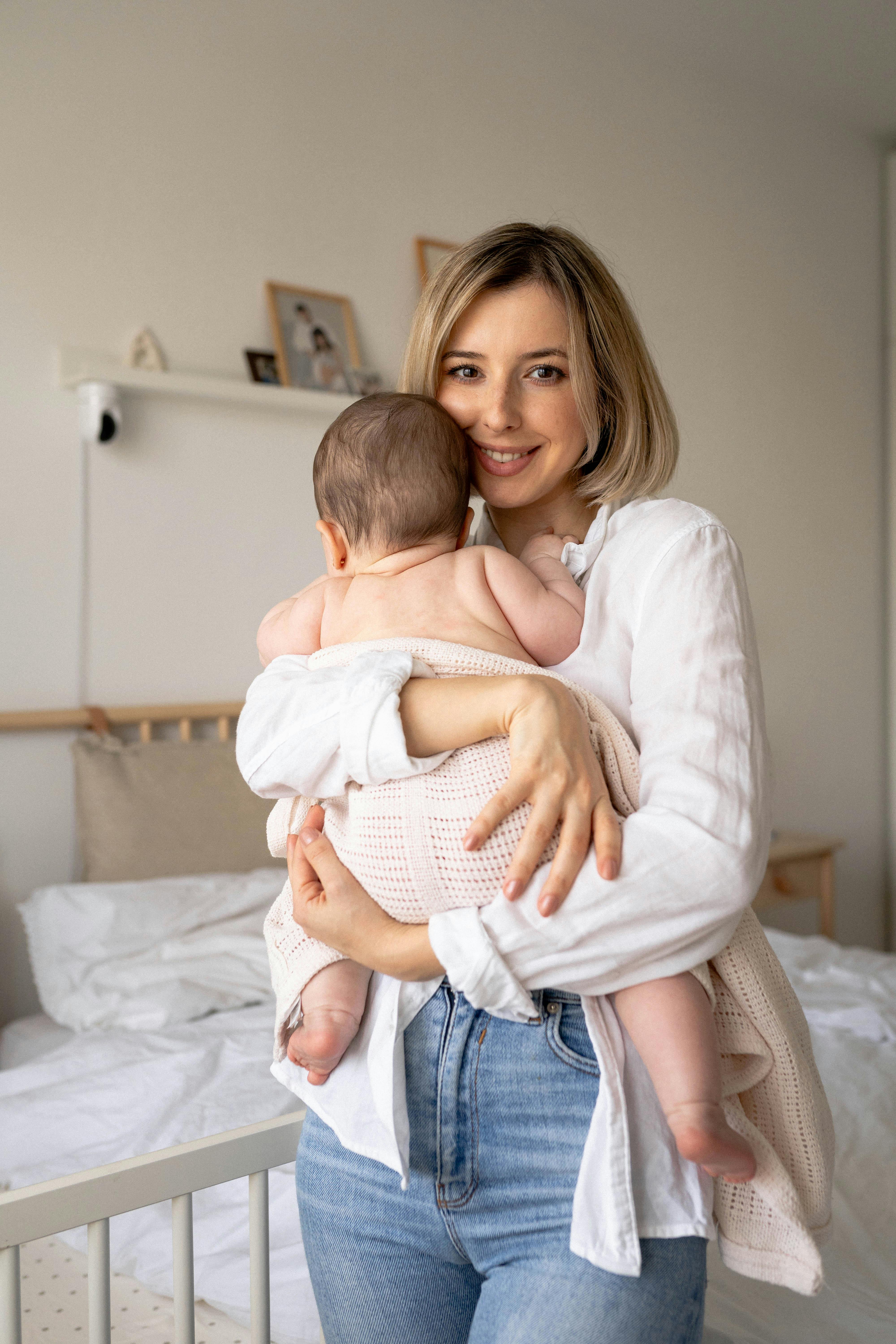 A happy woman holding her baby | Source: Pexels