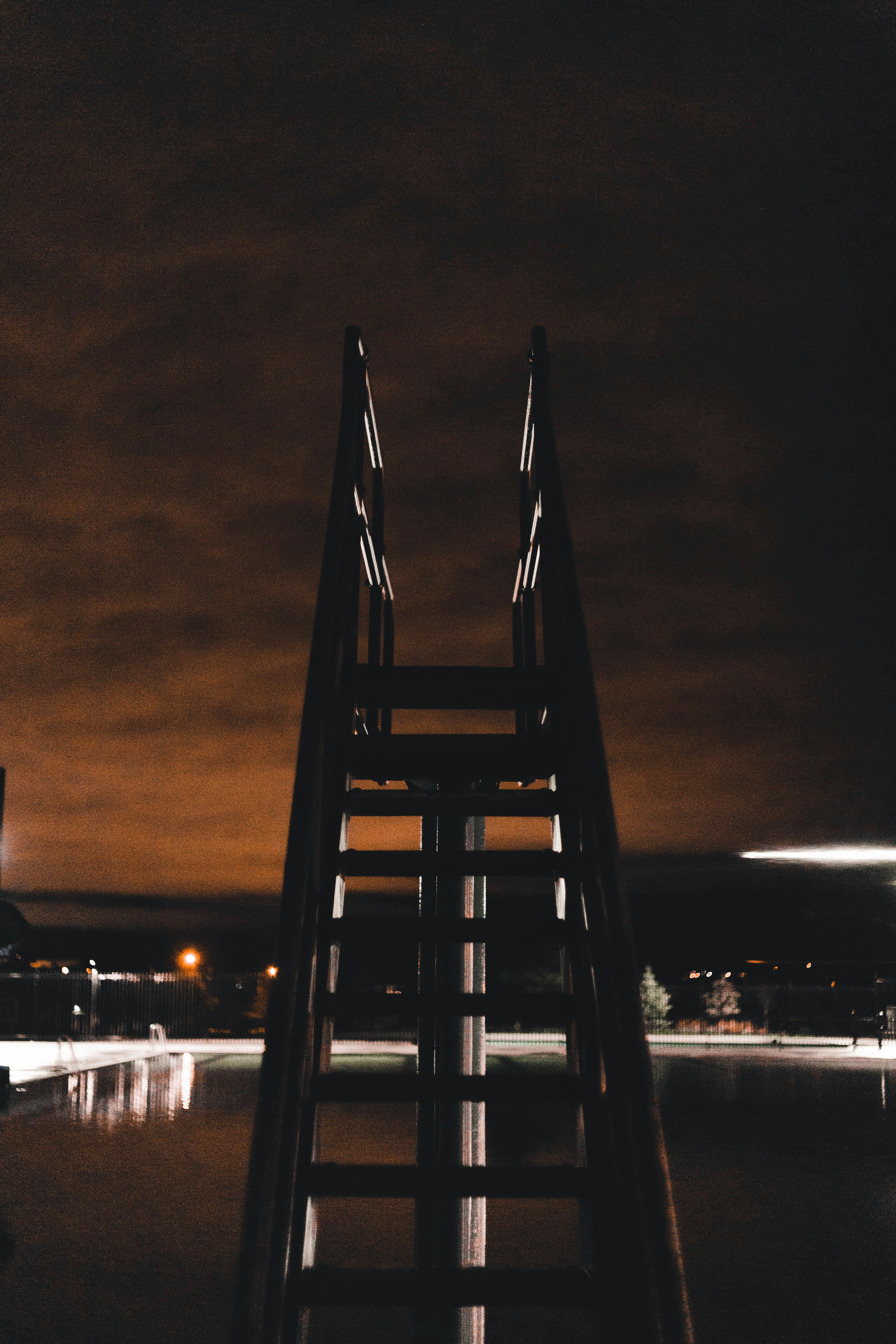 A diving board at a swimming pool at night | Source: Pexels