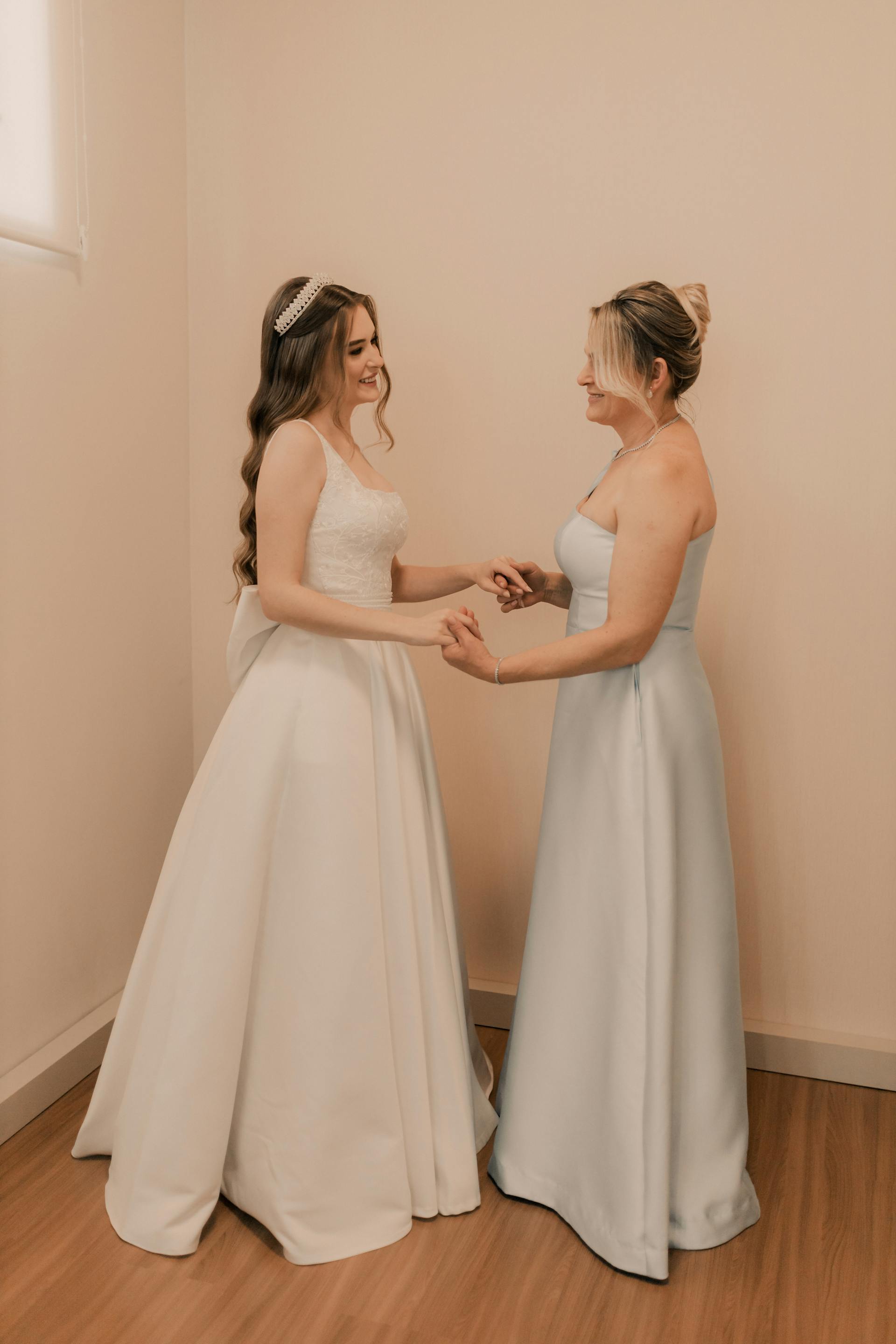 A bride and bridesmaid holding hands | Source: Pexels