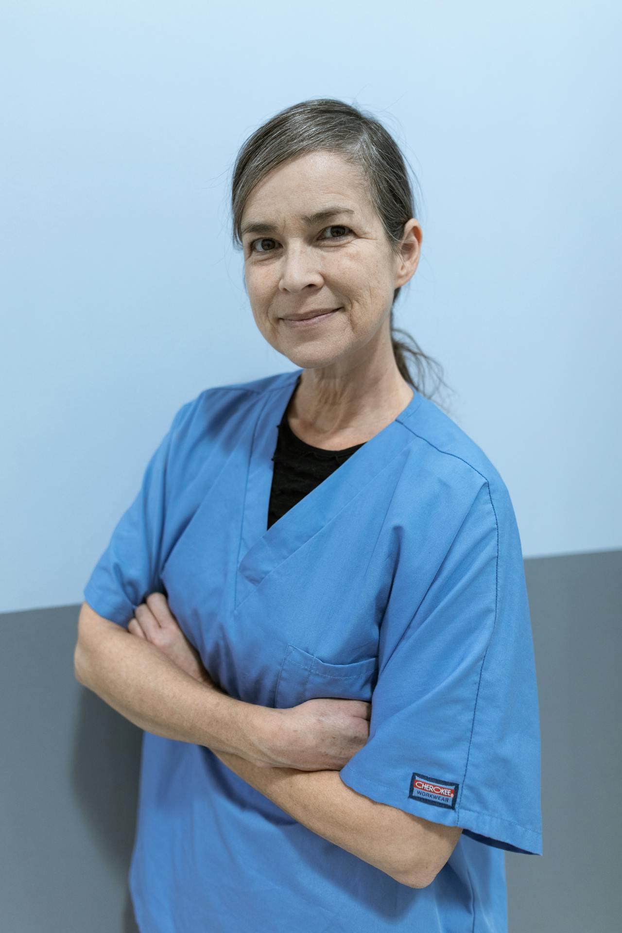 A senior woman in blue scrubs | Source: Pexels