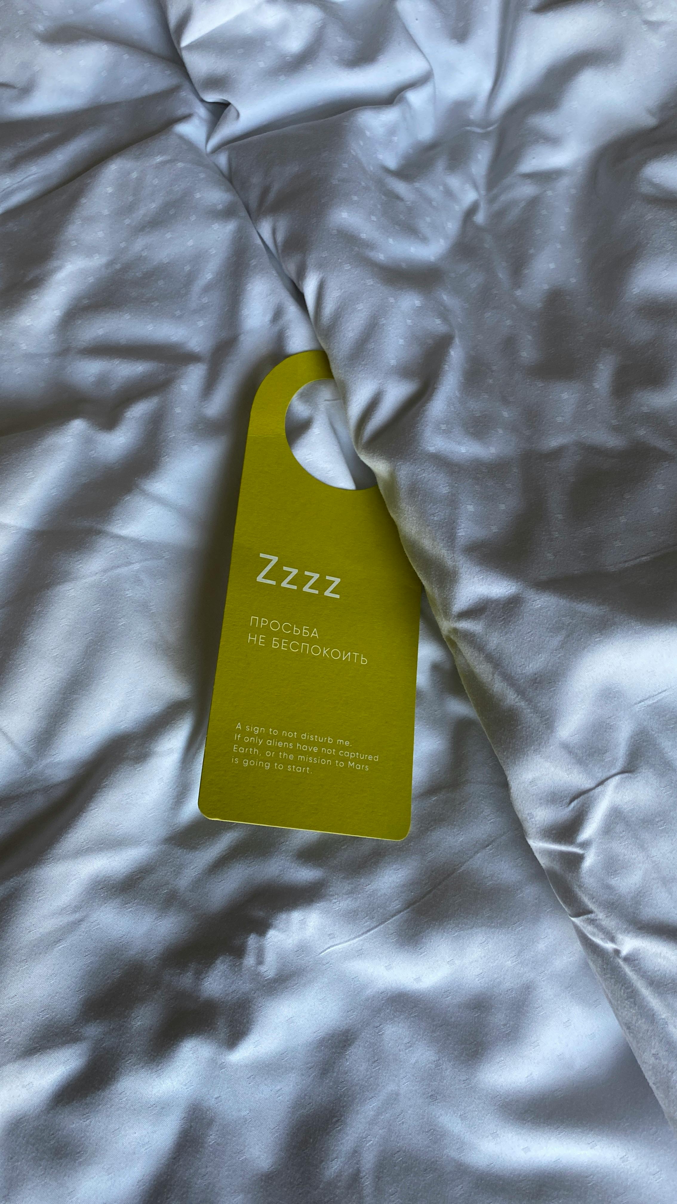 Hotel keycard placed on the bed | Source: Pexels