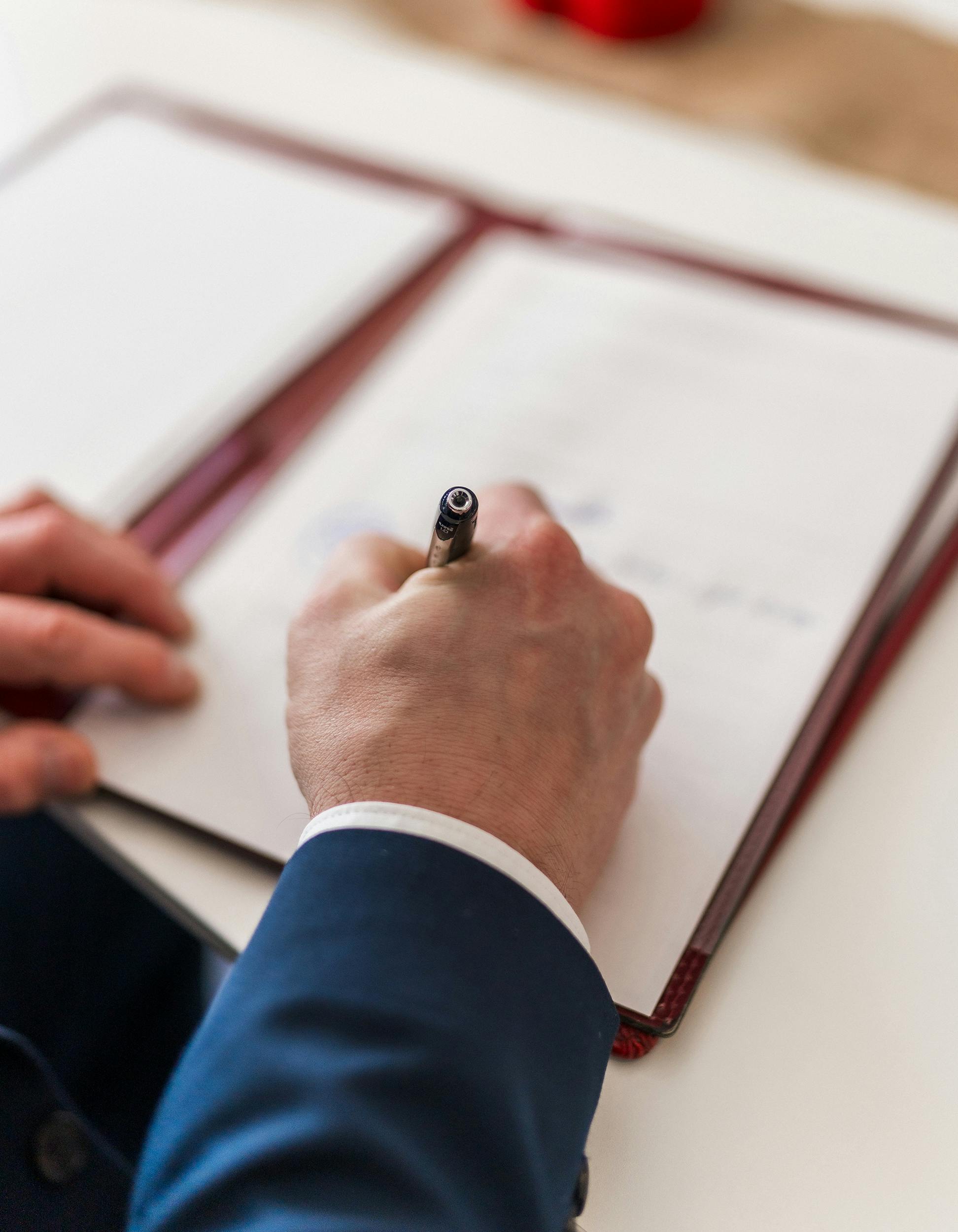 A man singing a document | Source: Pexels