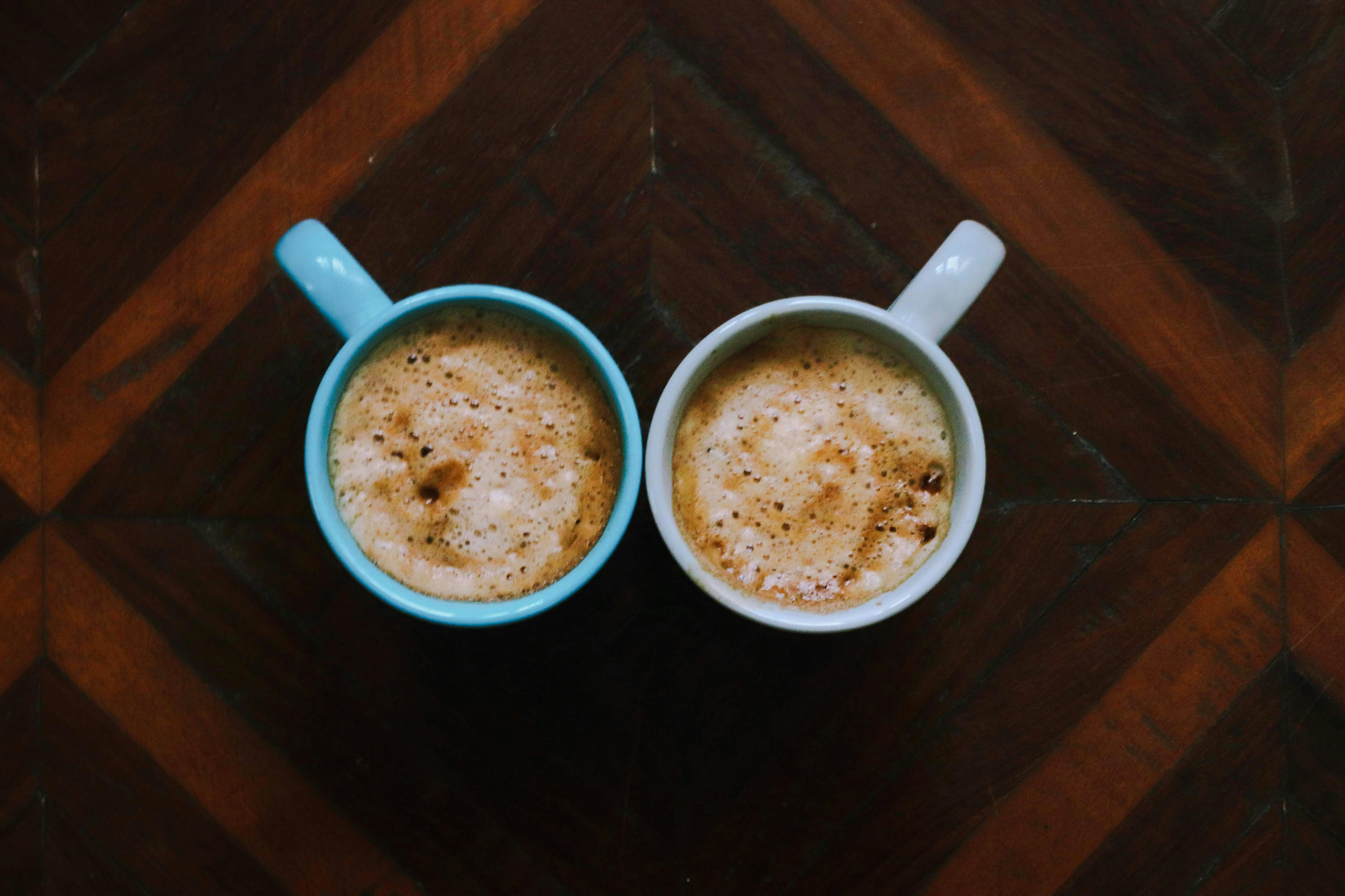 Two cups of coffee on a table | Source: Unsplash