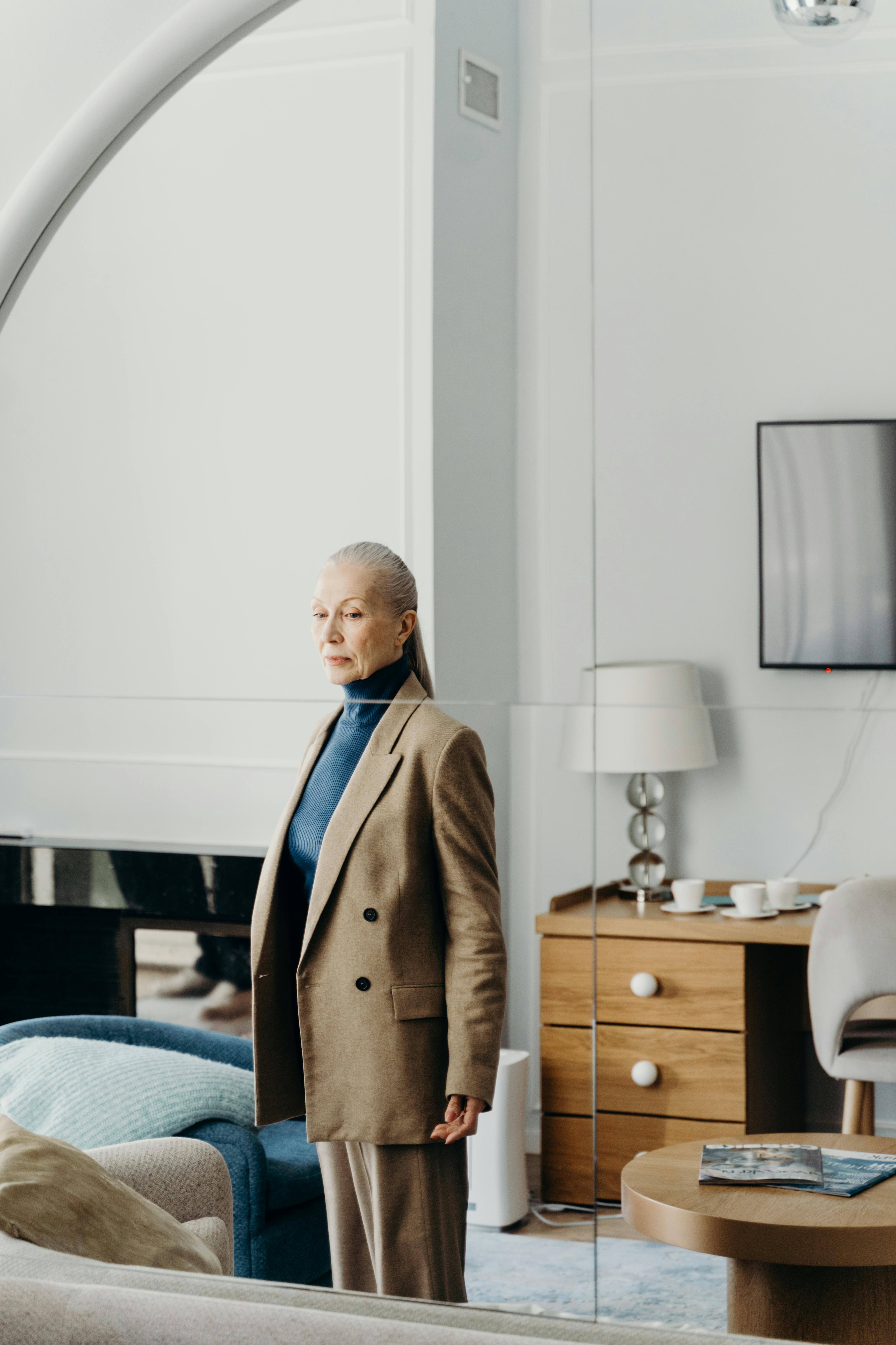 A woman looking at her reflection | Source: Pexels