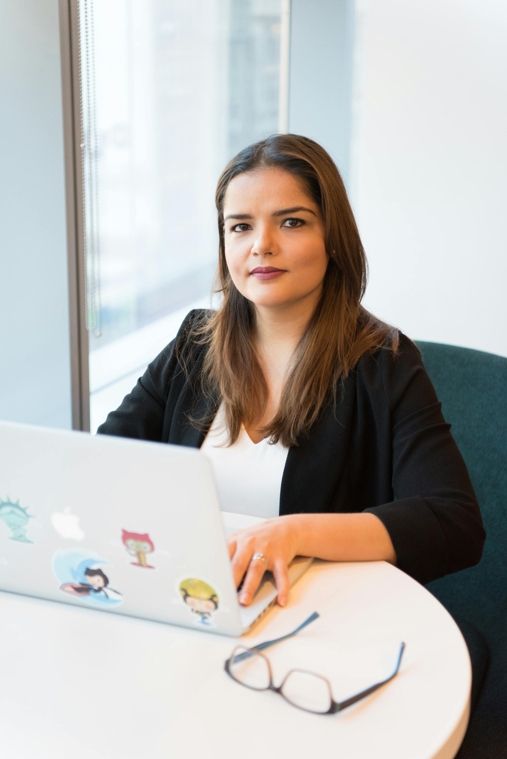 A serious woman sitting in front of a laptop | Source: Pexels