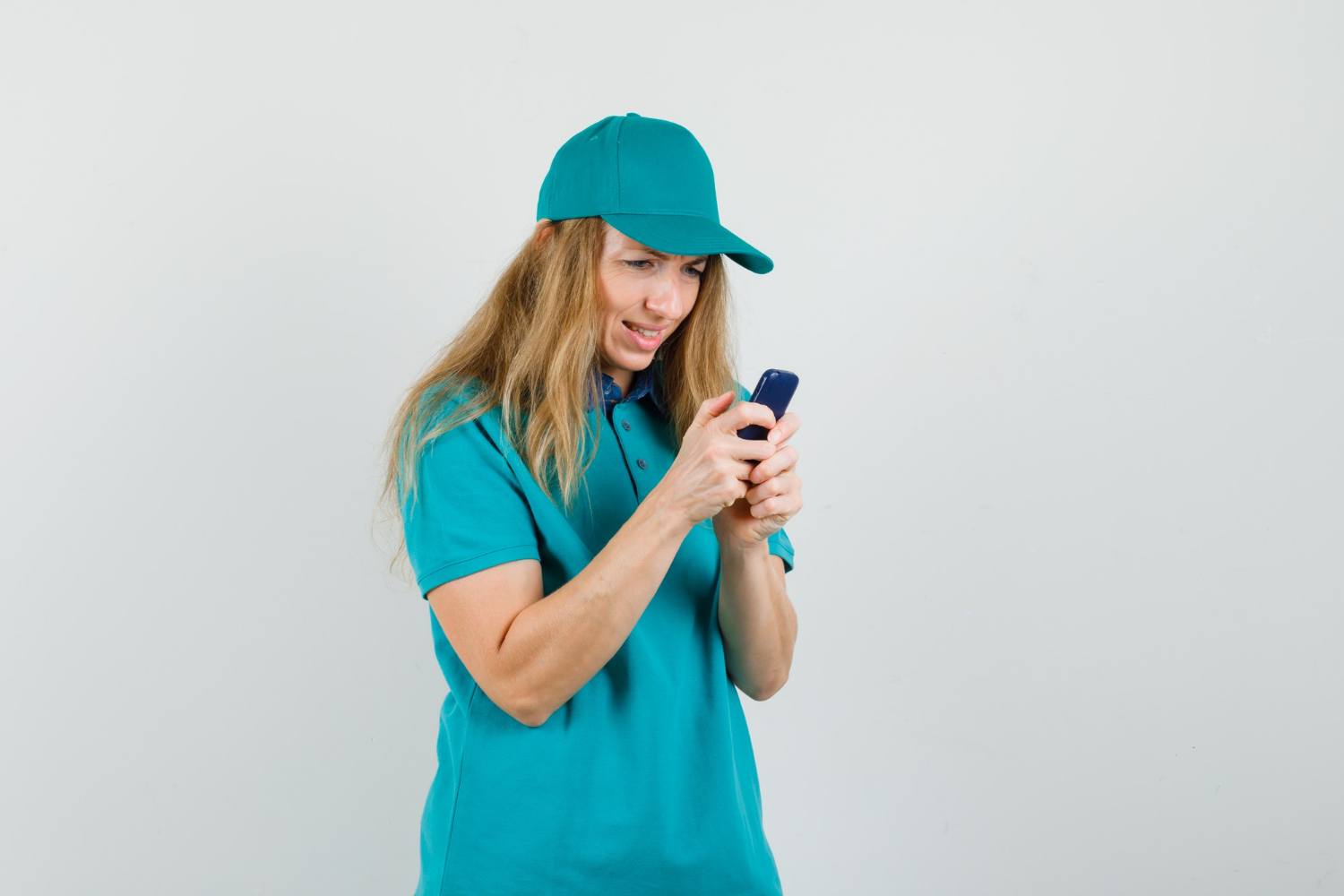 A smiling woman texting on her phone | Source: Freepik