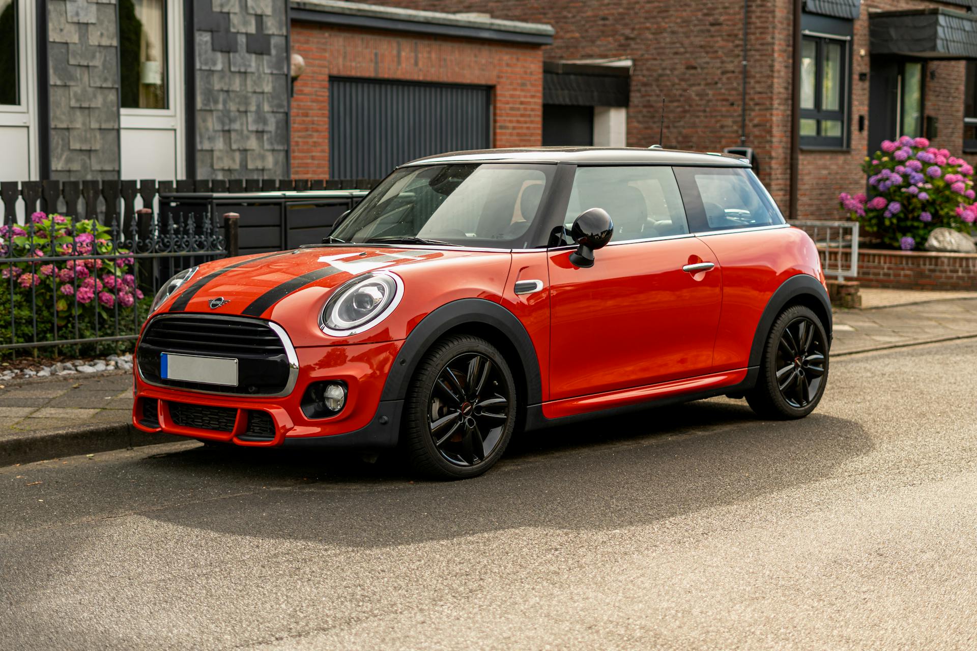 A red Mini Cooper parked outside a house | Source: Pexels