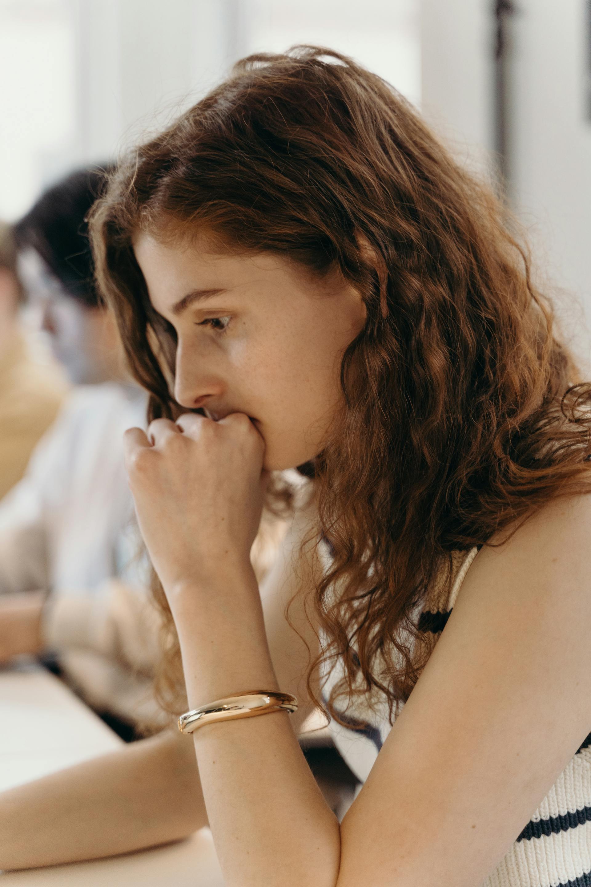 A thoughtful woman sitting at her desk in an office | Source: Pexels