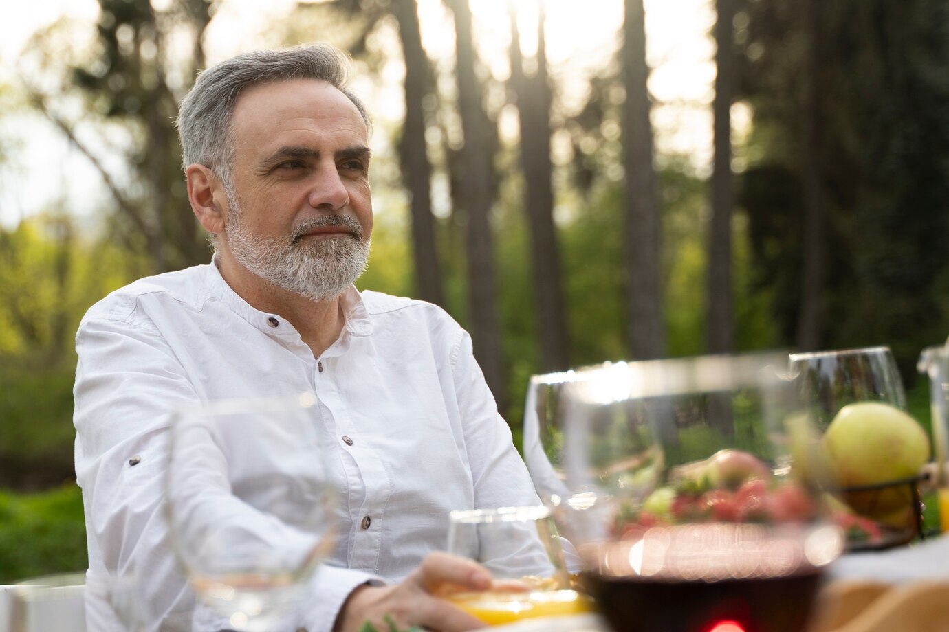 A serious man sitting at a table | Source: Freepik