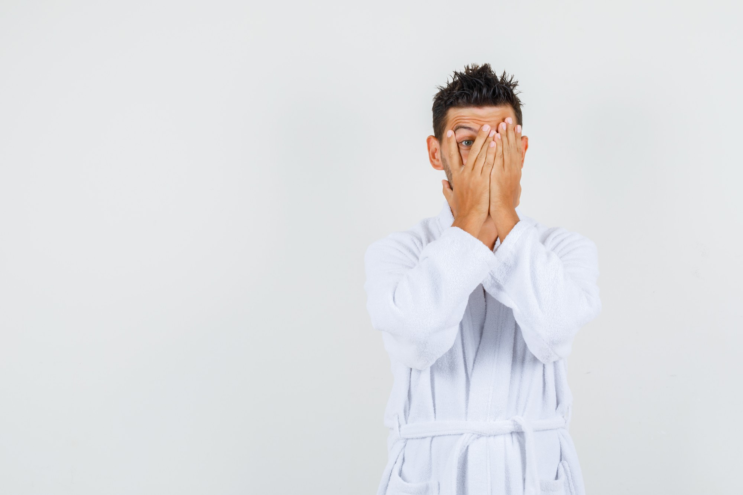 A terrified man in his bathrobe | Source: Freepik