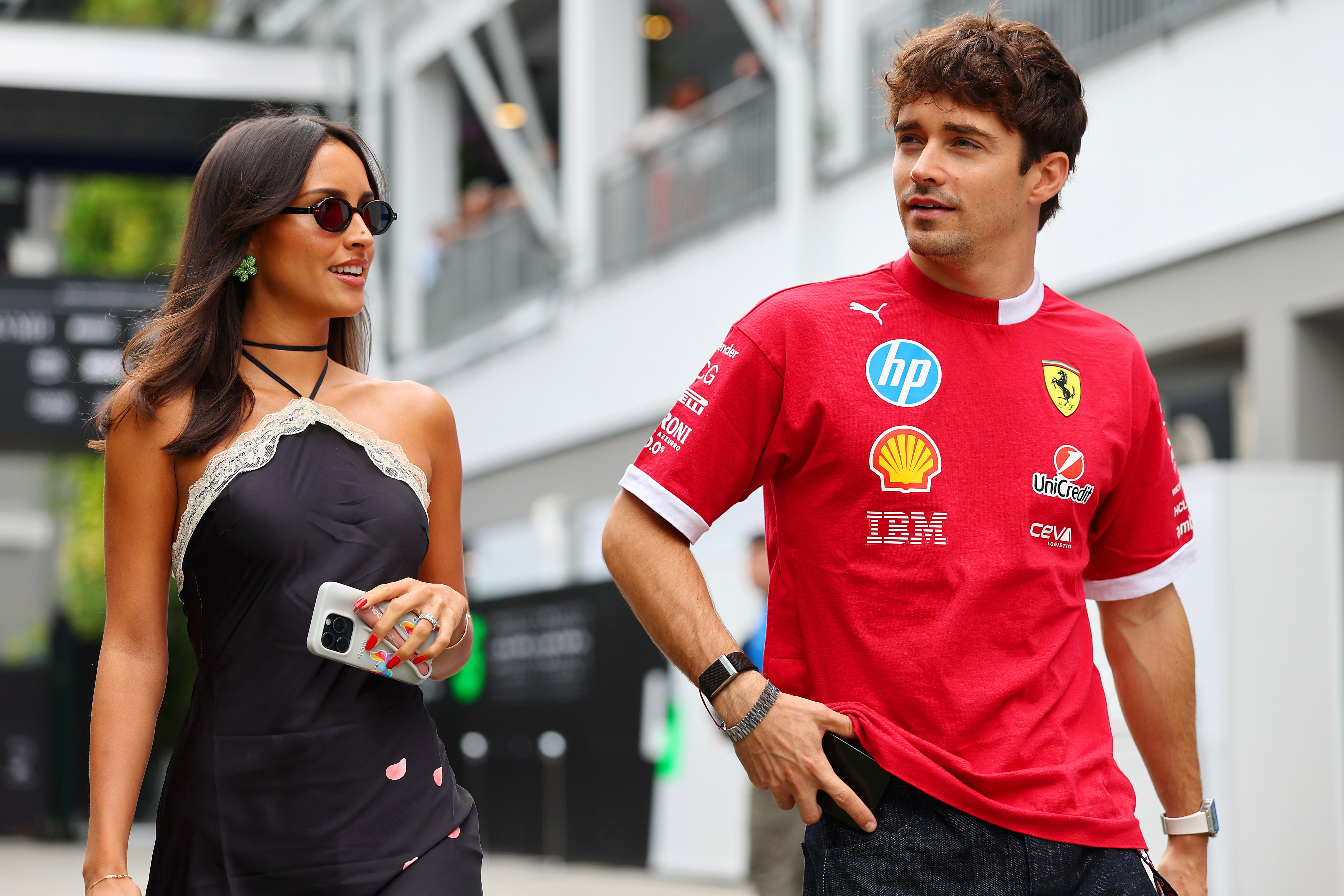 Charles Leclerc of Monaco and Scuderia Ferrari and Alexandra Saint Mleux arrive in the Paddock prior to practice ahead of the F1 Grand Prix of Singapore at Marina Bay Street Circuit on October 03, 2025 in Singapore, Singapore. | Source: Getty Images