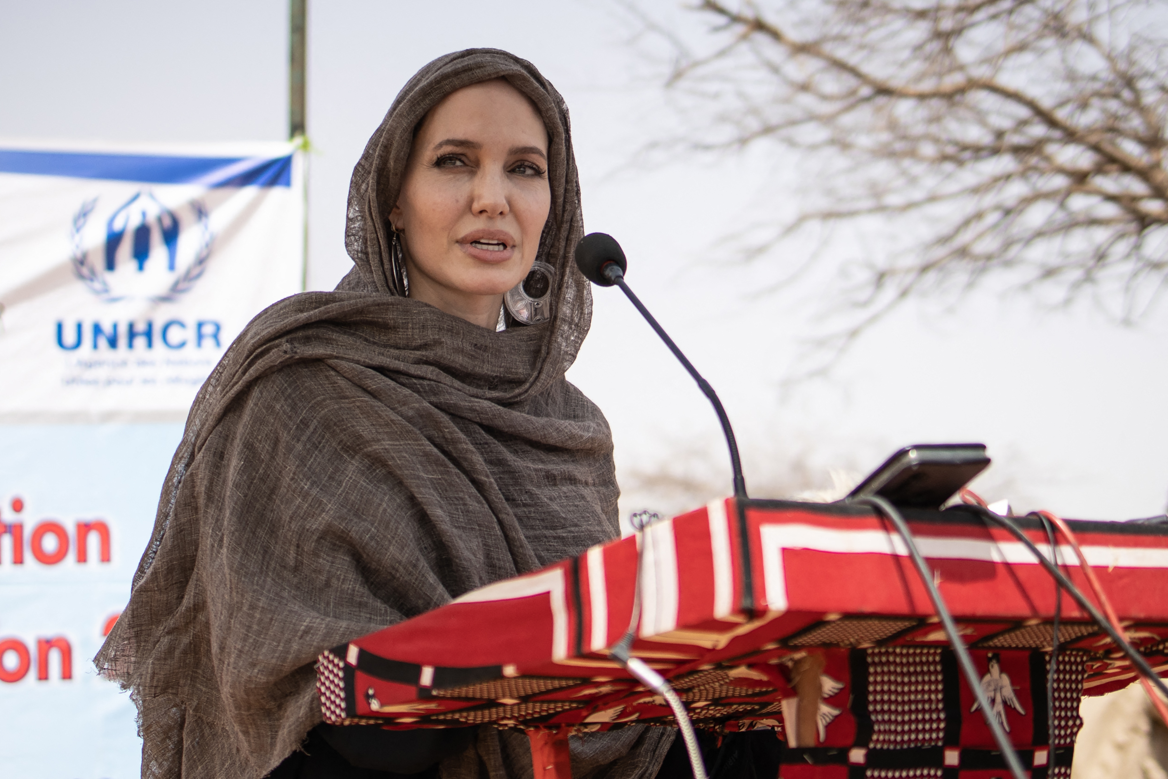 Angelina Jolie, United Nations High Commissioner for Refugees (UNHCR) special envoy, gives a statement in Goudebou, a camp that welcomes more than 11,000 Malian refugees in northern Burkina Faso, on International Refugee Day on June 20, 2021. | Source: Getty Images