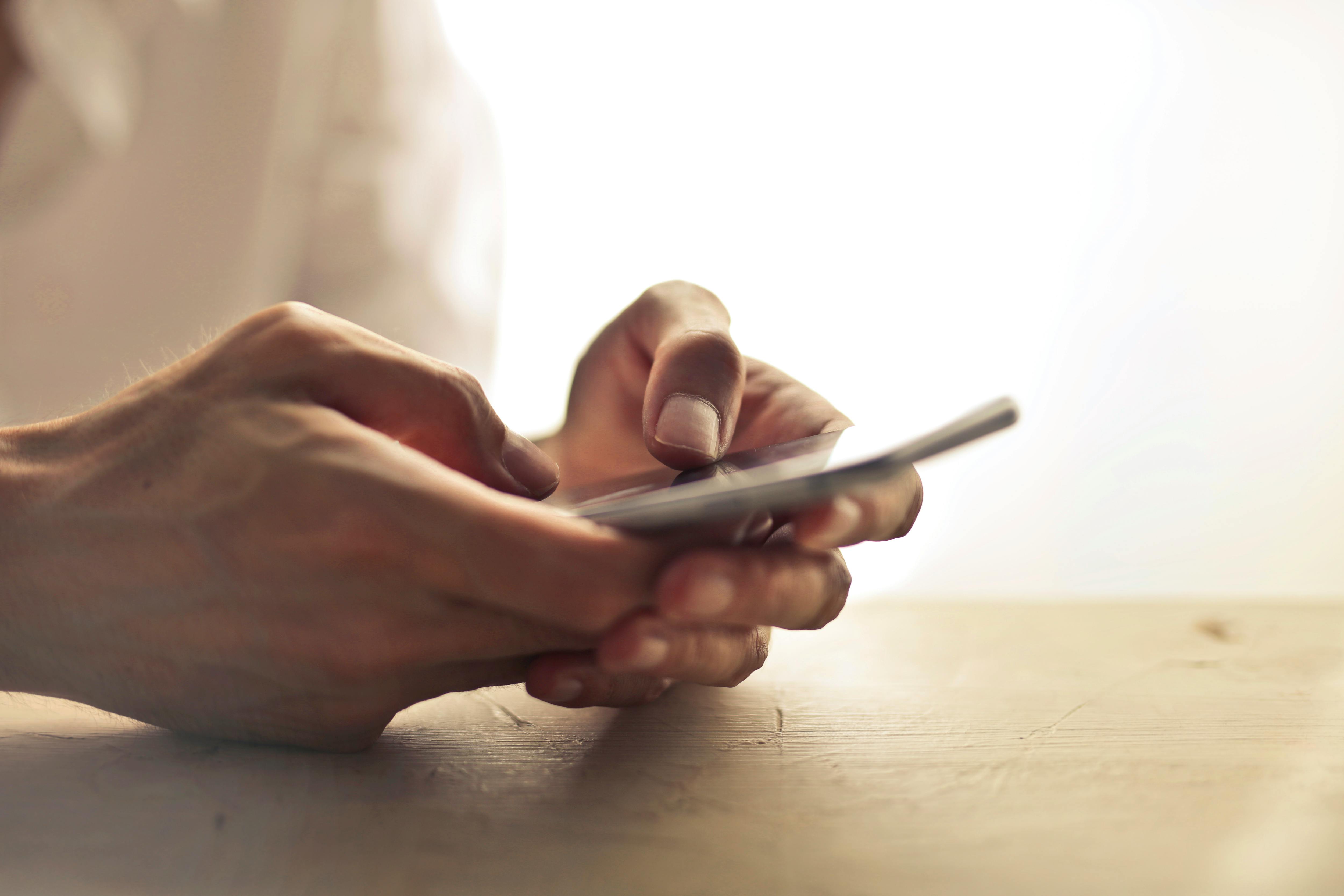 A woman holding a phone | Source: Pexels