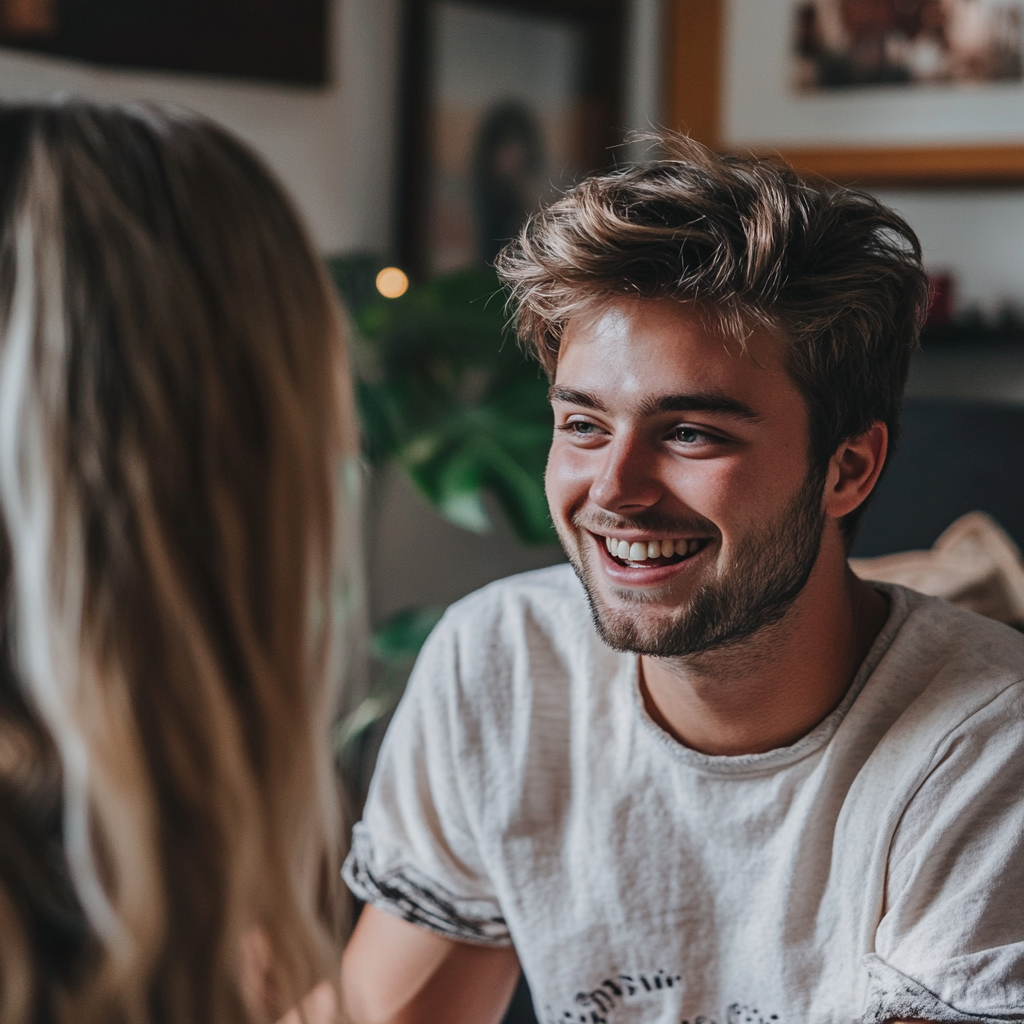 A laughing man talking to his wife in their living room | Source: Midjourney