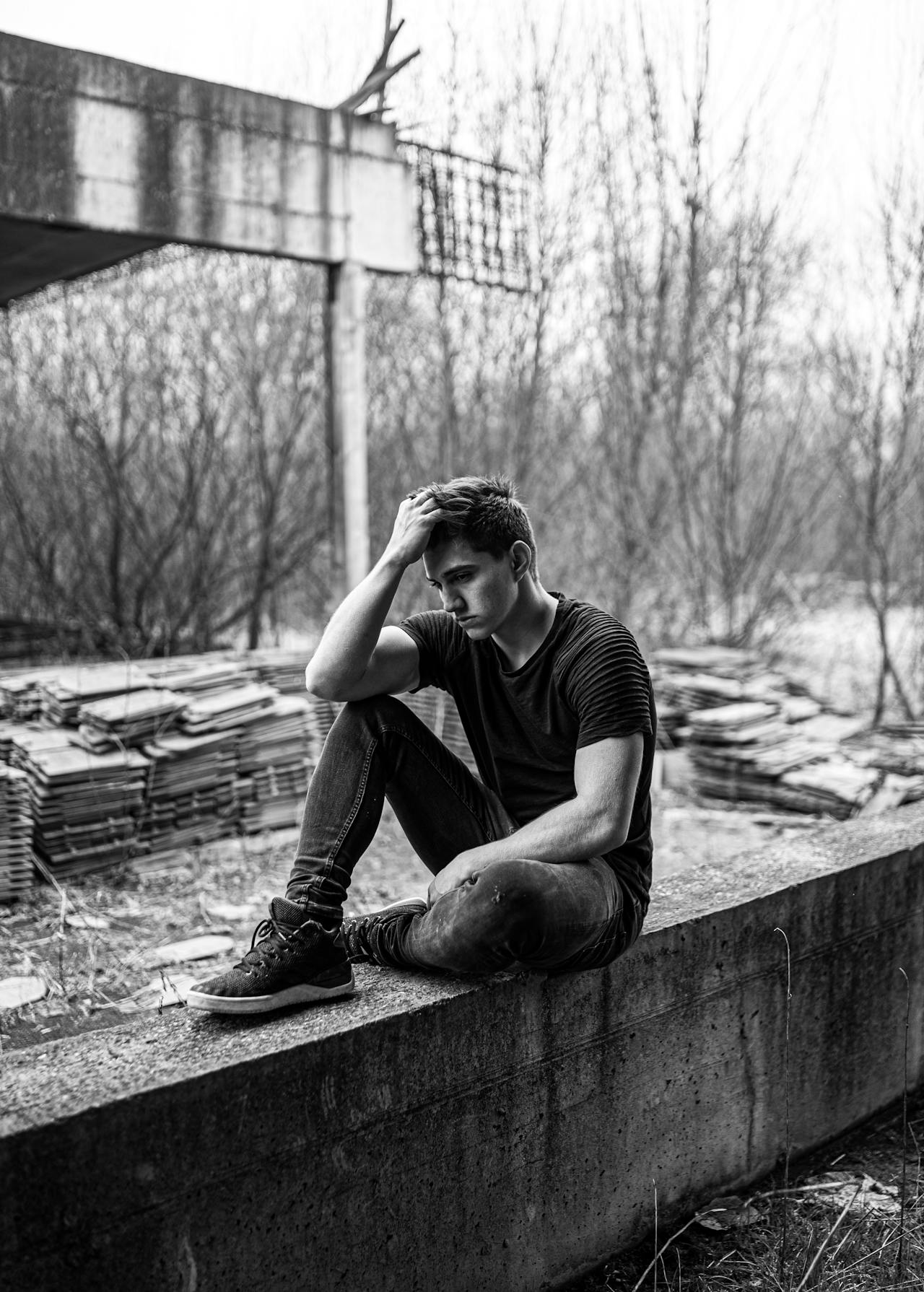 Grayscale shot of a sad young man | Source: Pexels