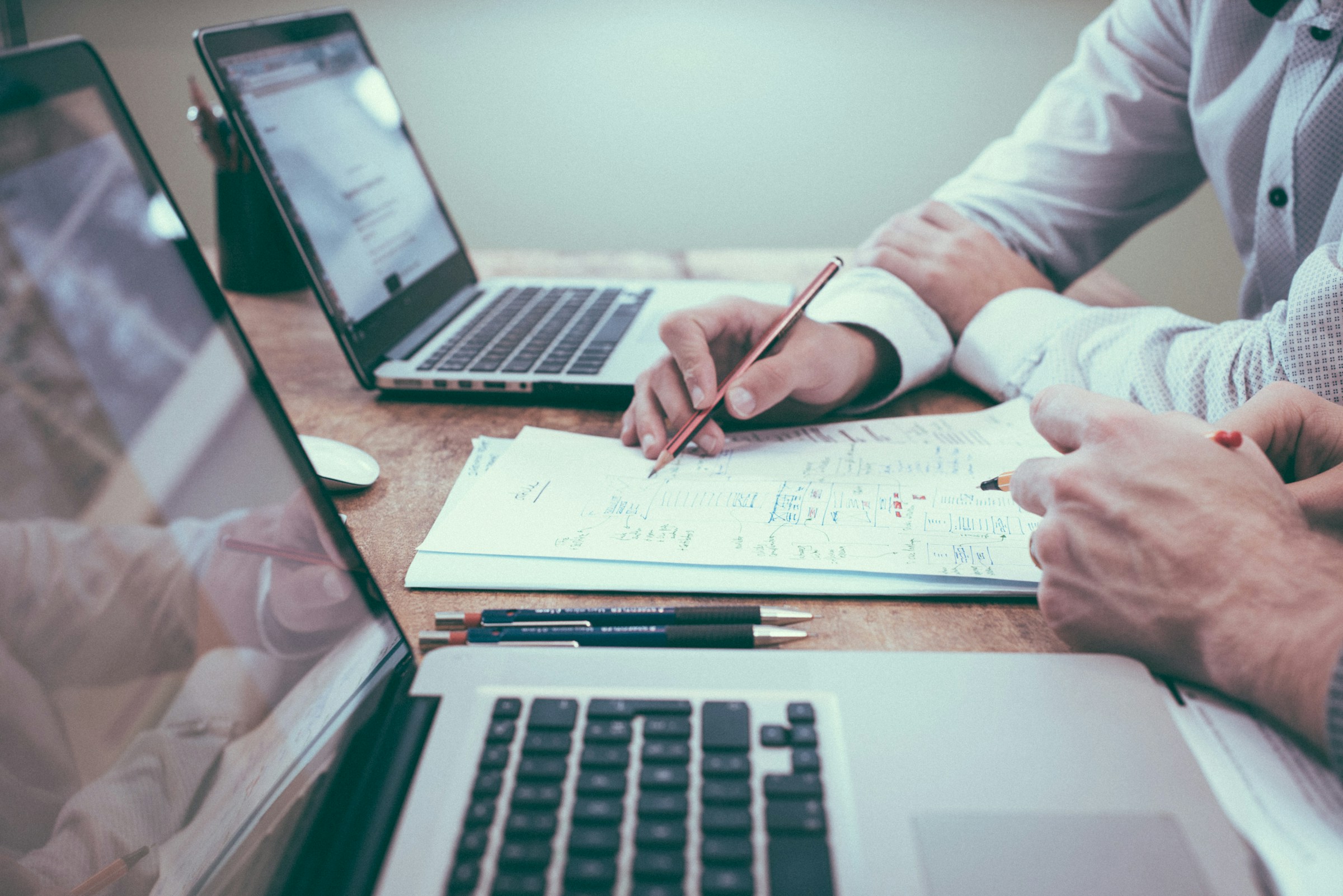 People with laptops in a meeting | Source: Unsplash