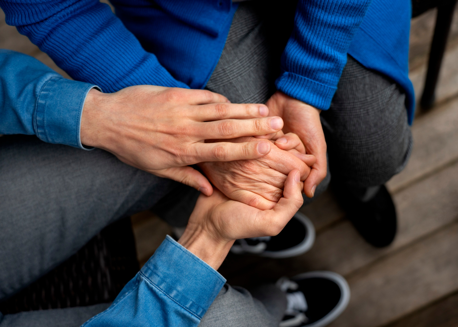 A young man holding an older person's hand | Source: Freepik
