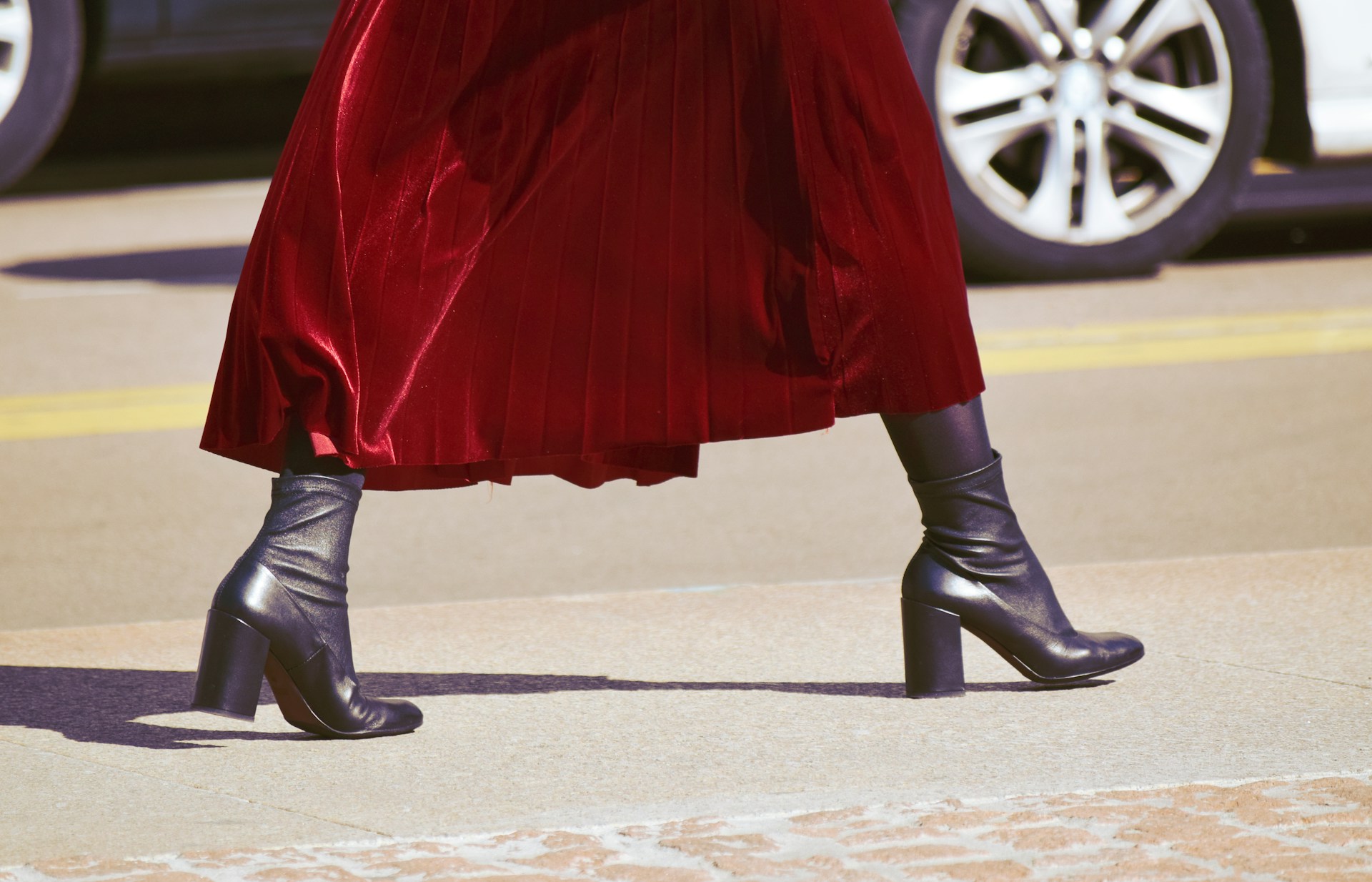 Close-up shot of a woman walking near a car | Source: Unsplash