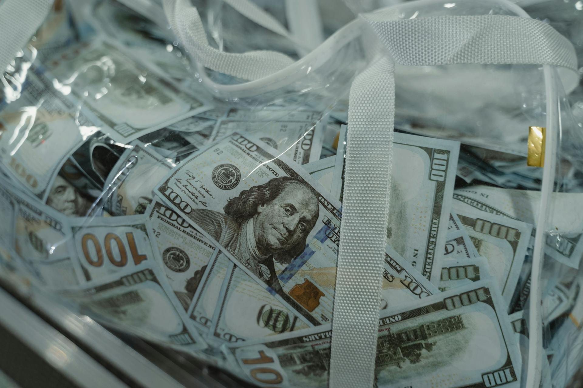 A transparent bag containing US dollar bills | Source: Pexels