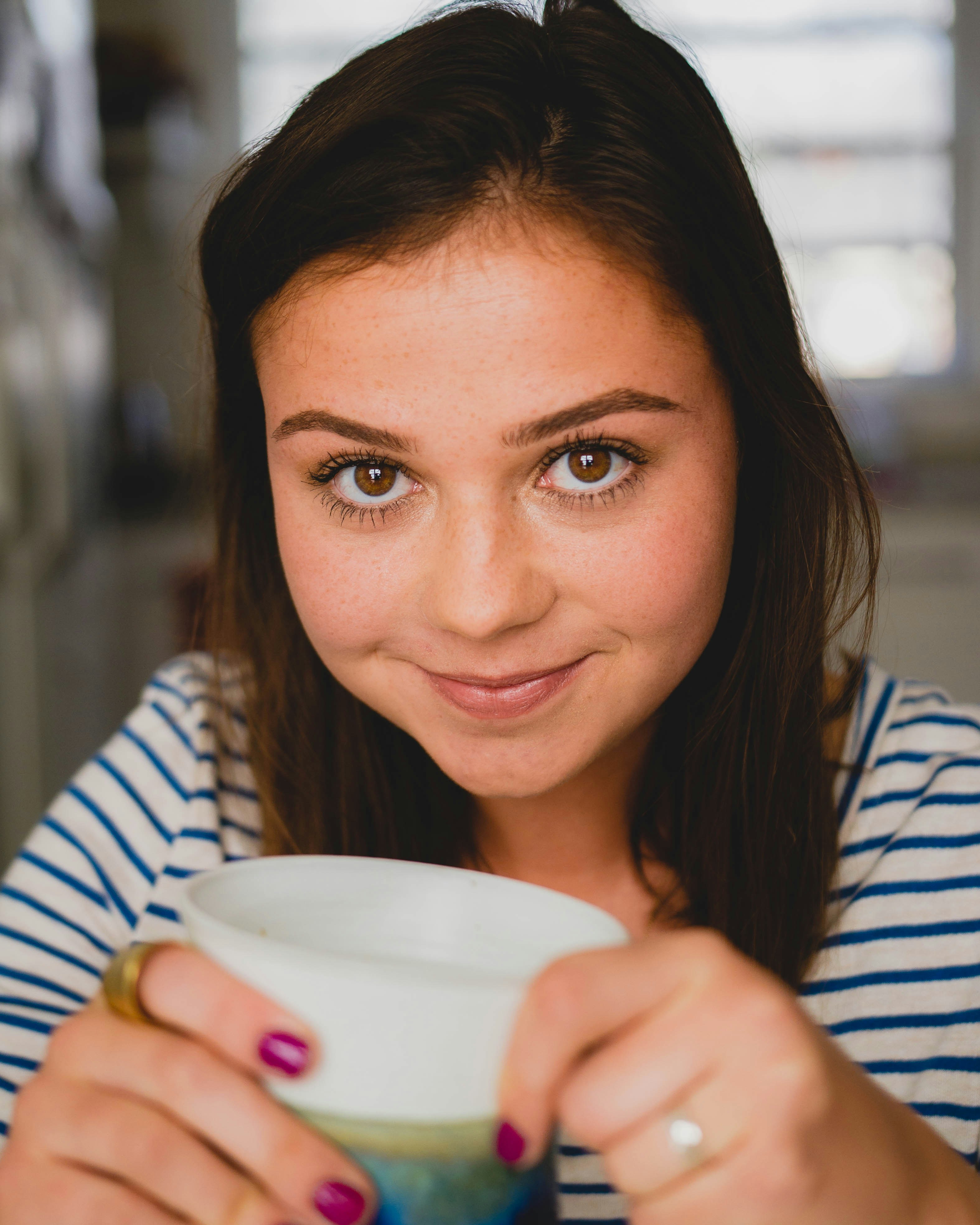 A happy girl holding a mug | Source: Unsplash