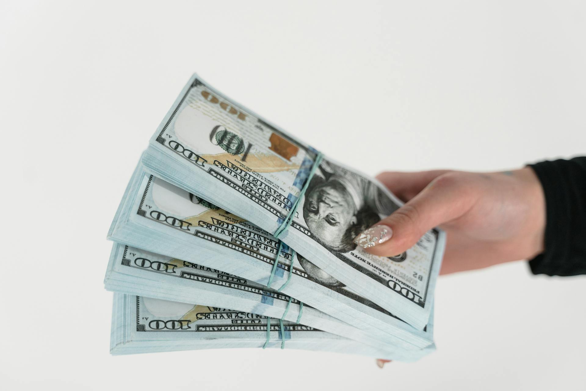 A woman holding money | Source: Pexels