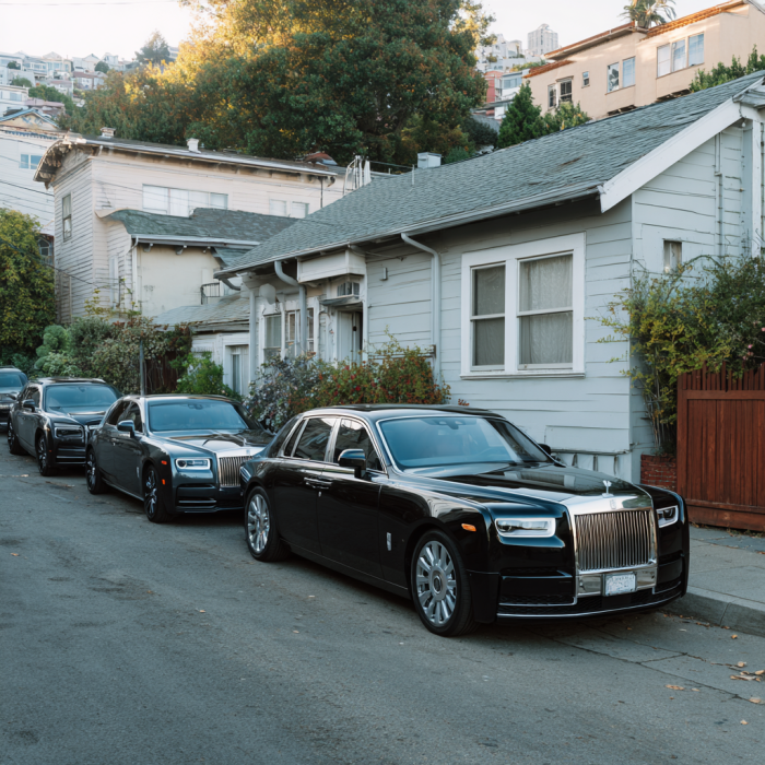 Several black Rolls-Royces lined on the street | Source: Midjourney