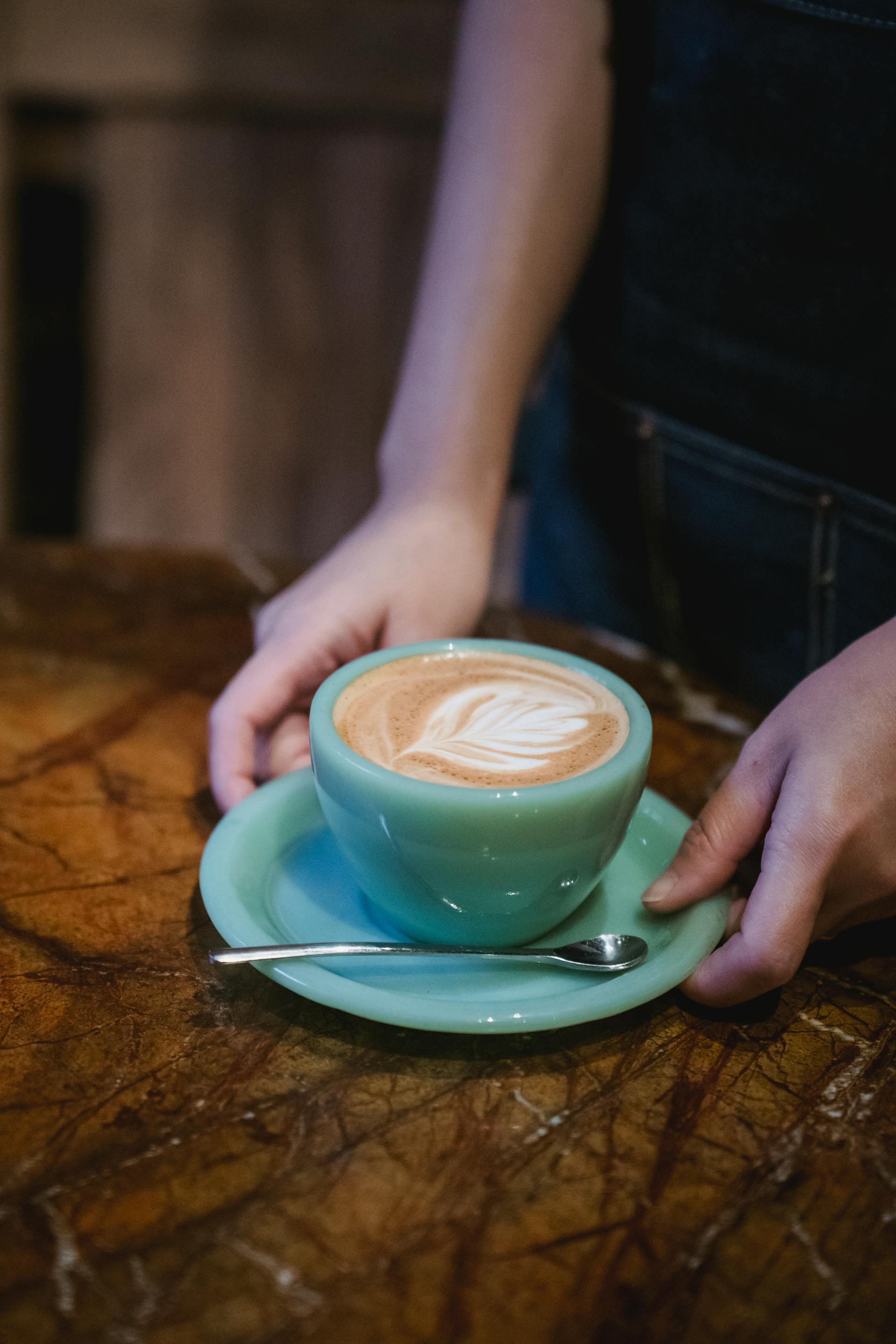 Close-up shot of a woman holding a cup of coffee | Source: Pexels