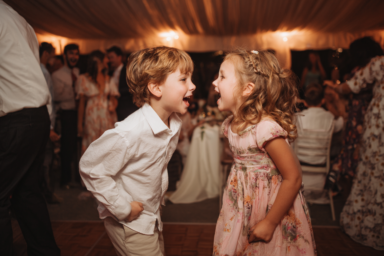 Excited kids at a wedding reception | Source: Midjourney