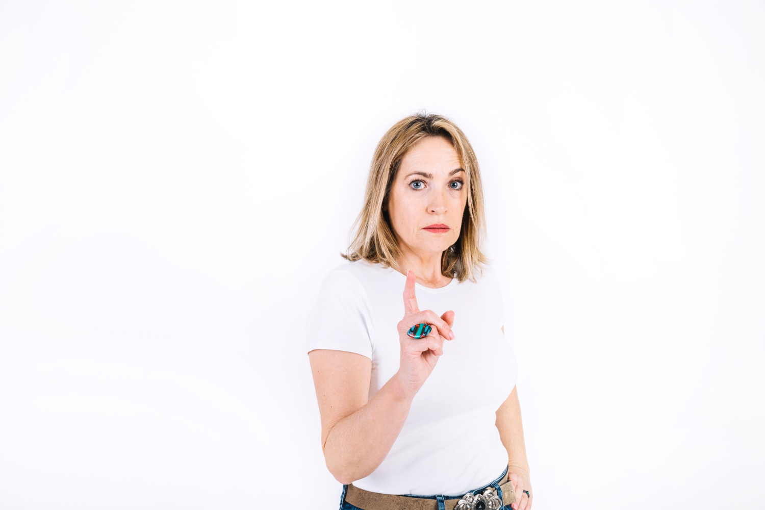 A stern senior woman gesturing with a warning | Source: Freepik