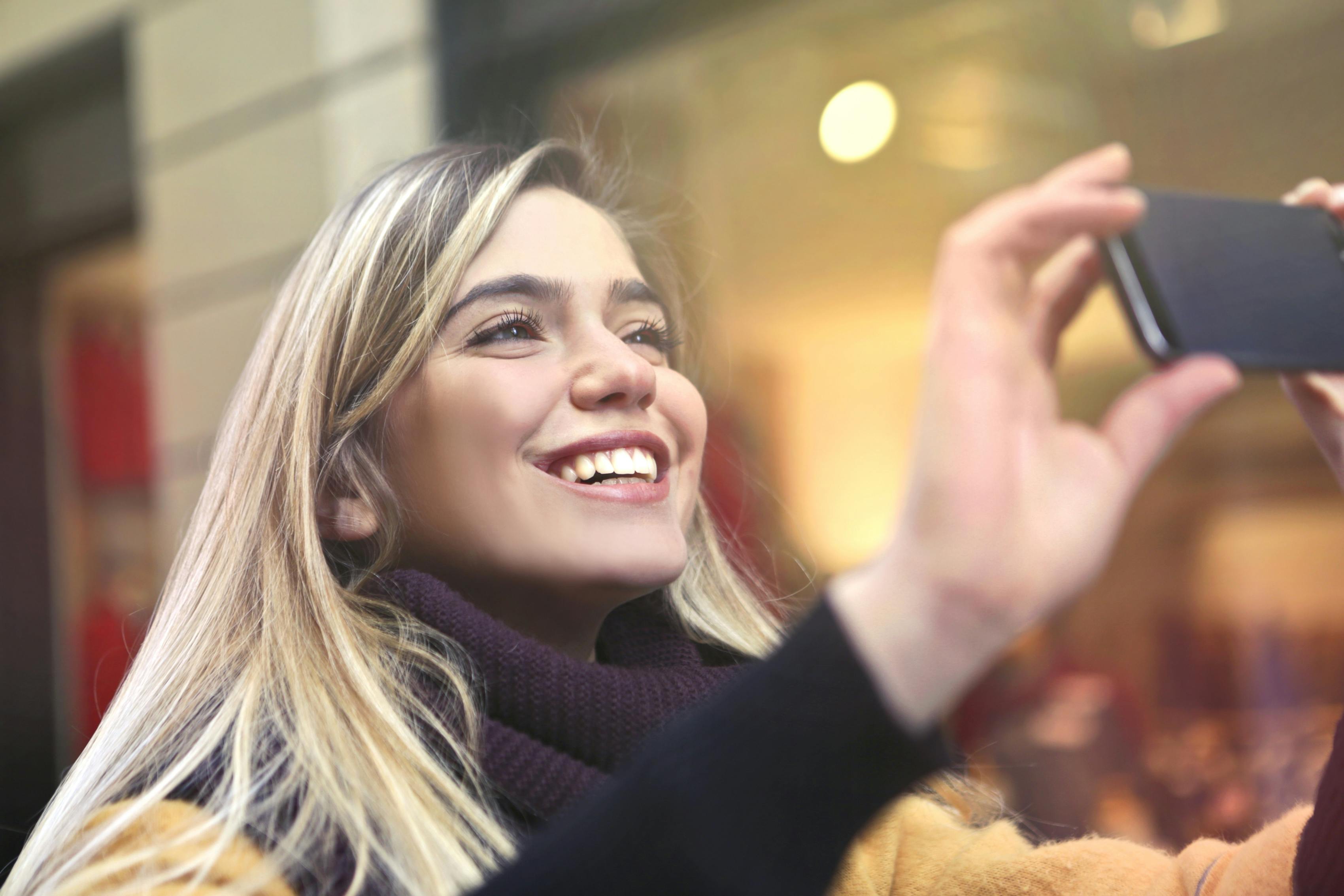 A happy woman taking photos | Source: Pexels