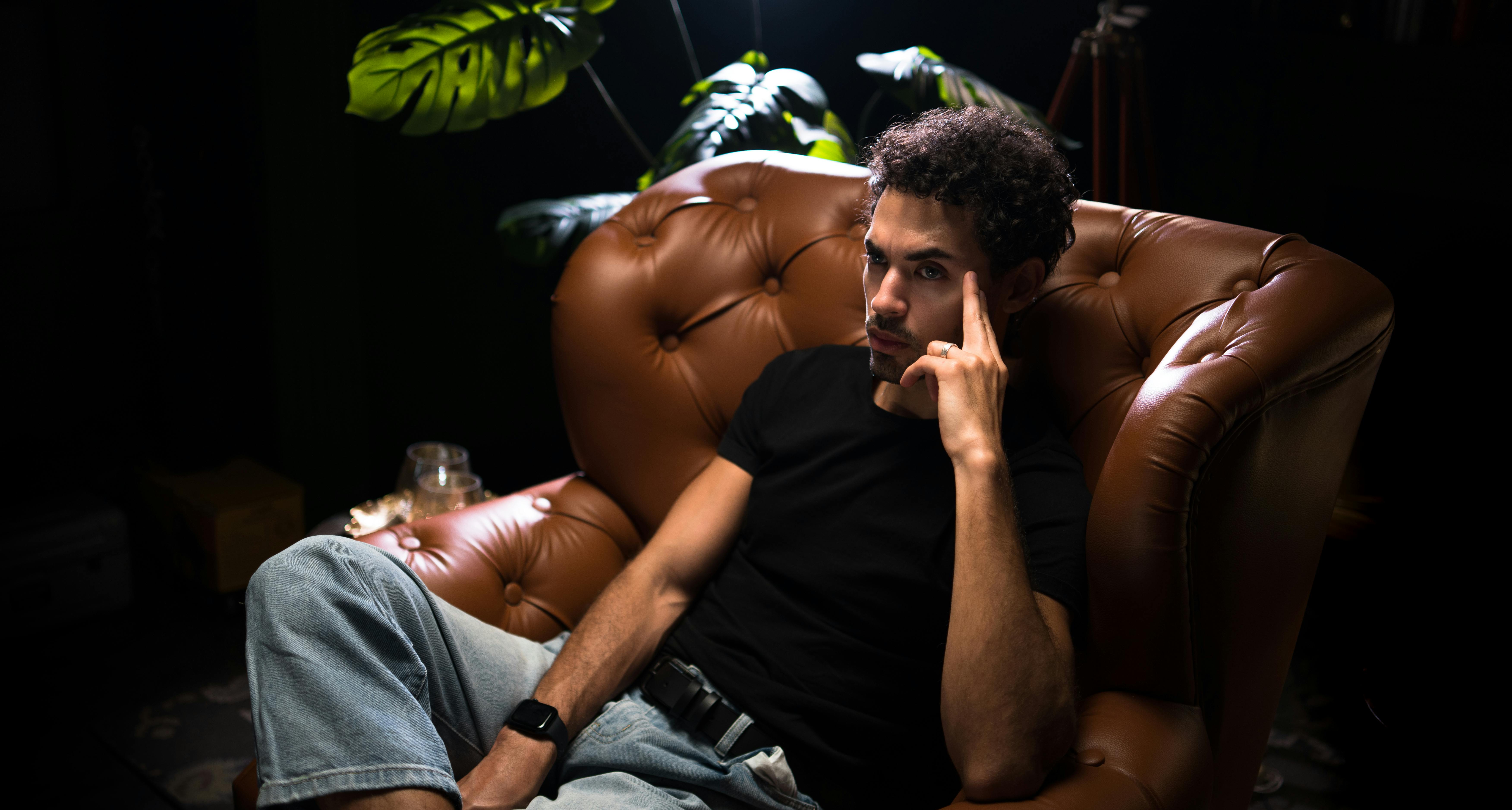 A serious man sitting on a leather chair | Source: Pexels