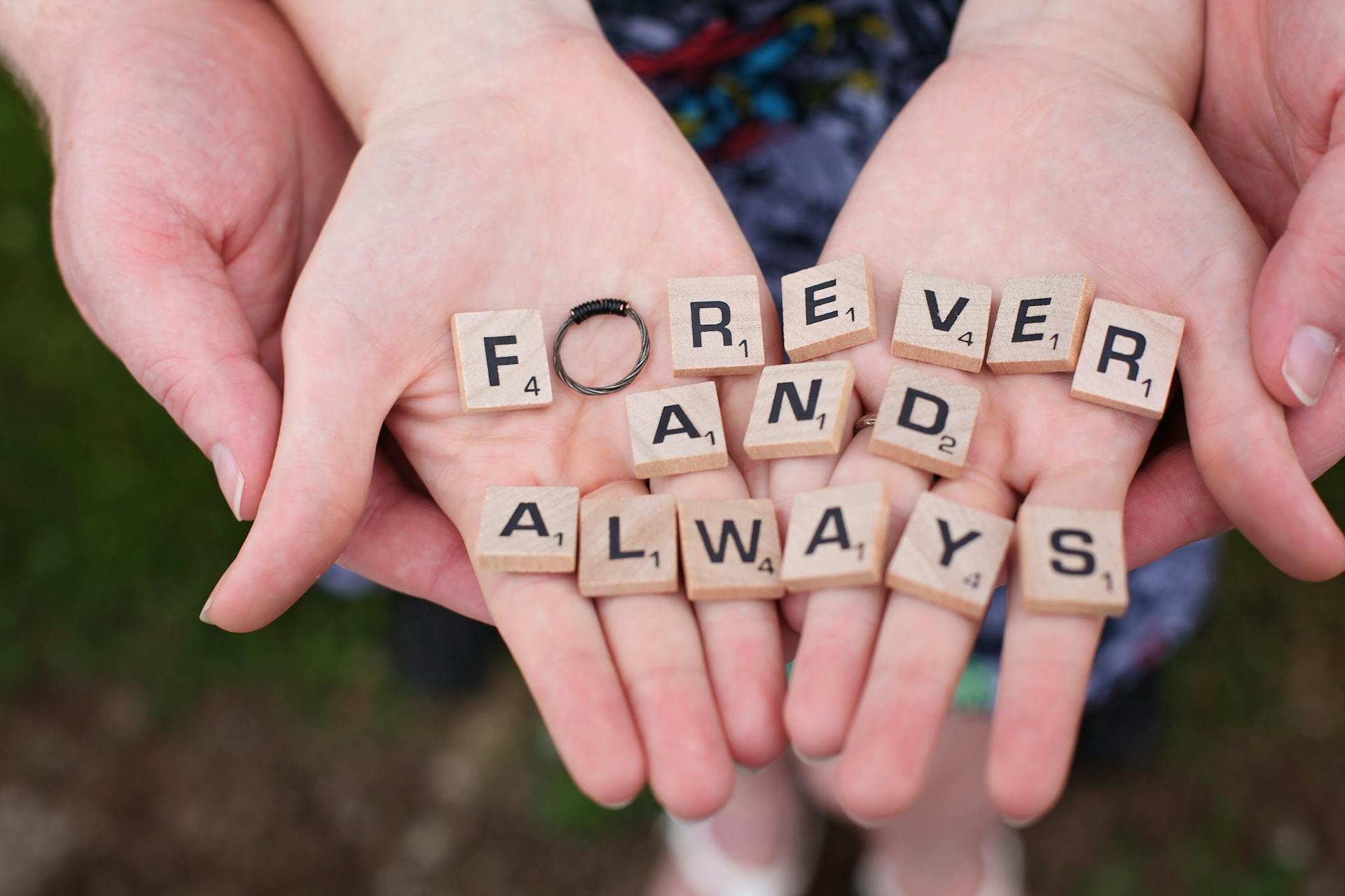 Two hands holding name letter blocks | Source: Pexels