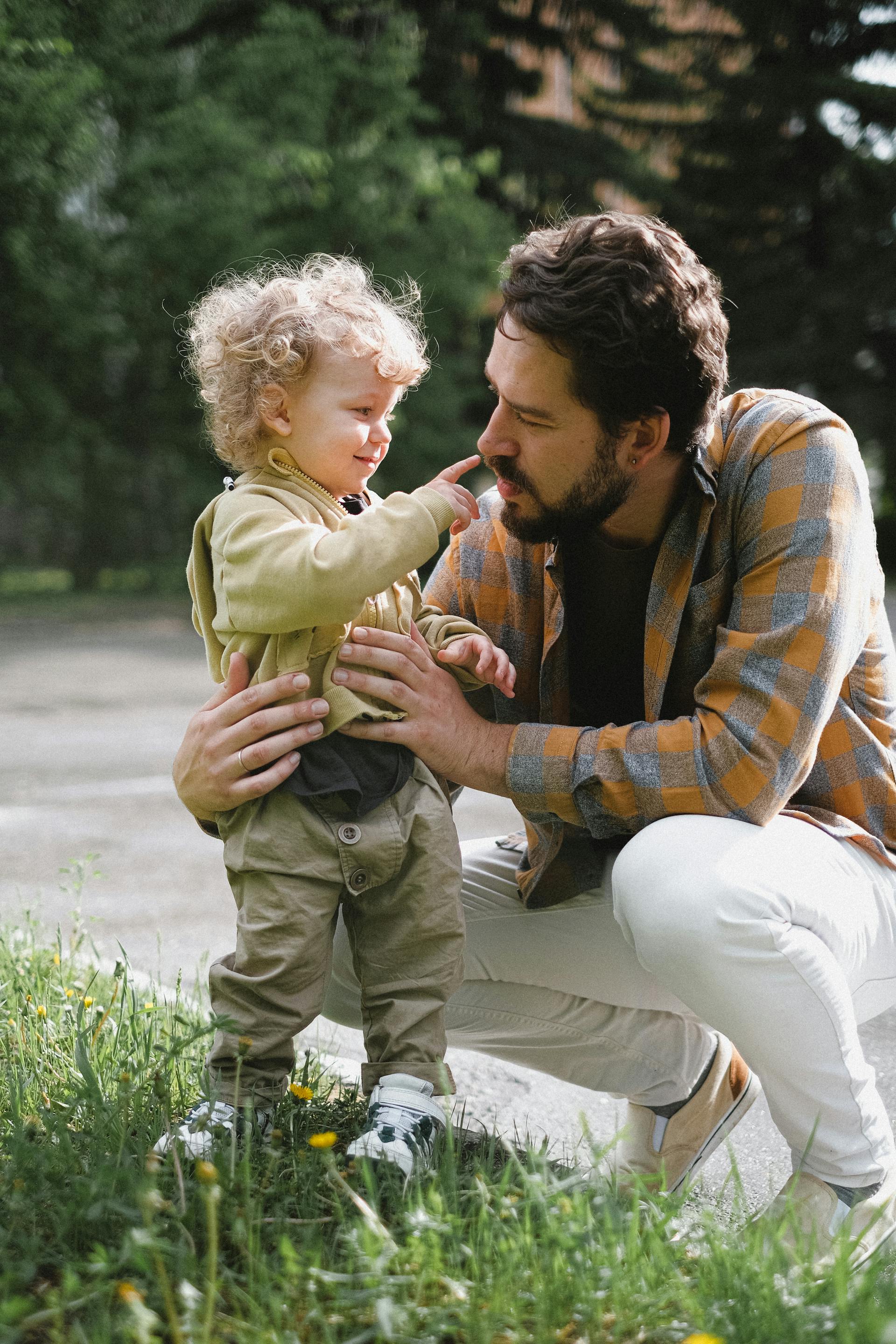 A father and son sharing a sweet moment outside | Source: Pexels