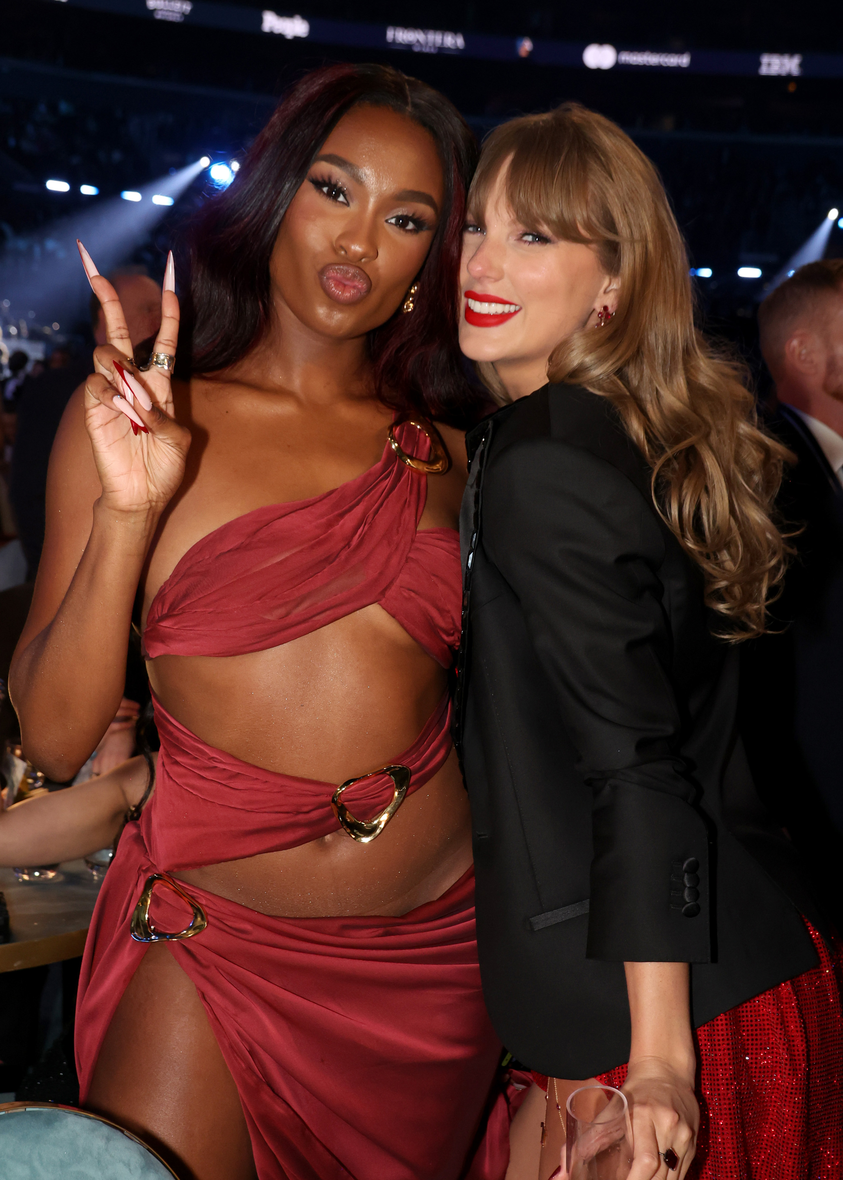 Coco Jones and Taylor Swift posing at the 67th Annual Grammy Awards | Source: Getty Images