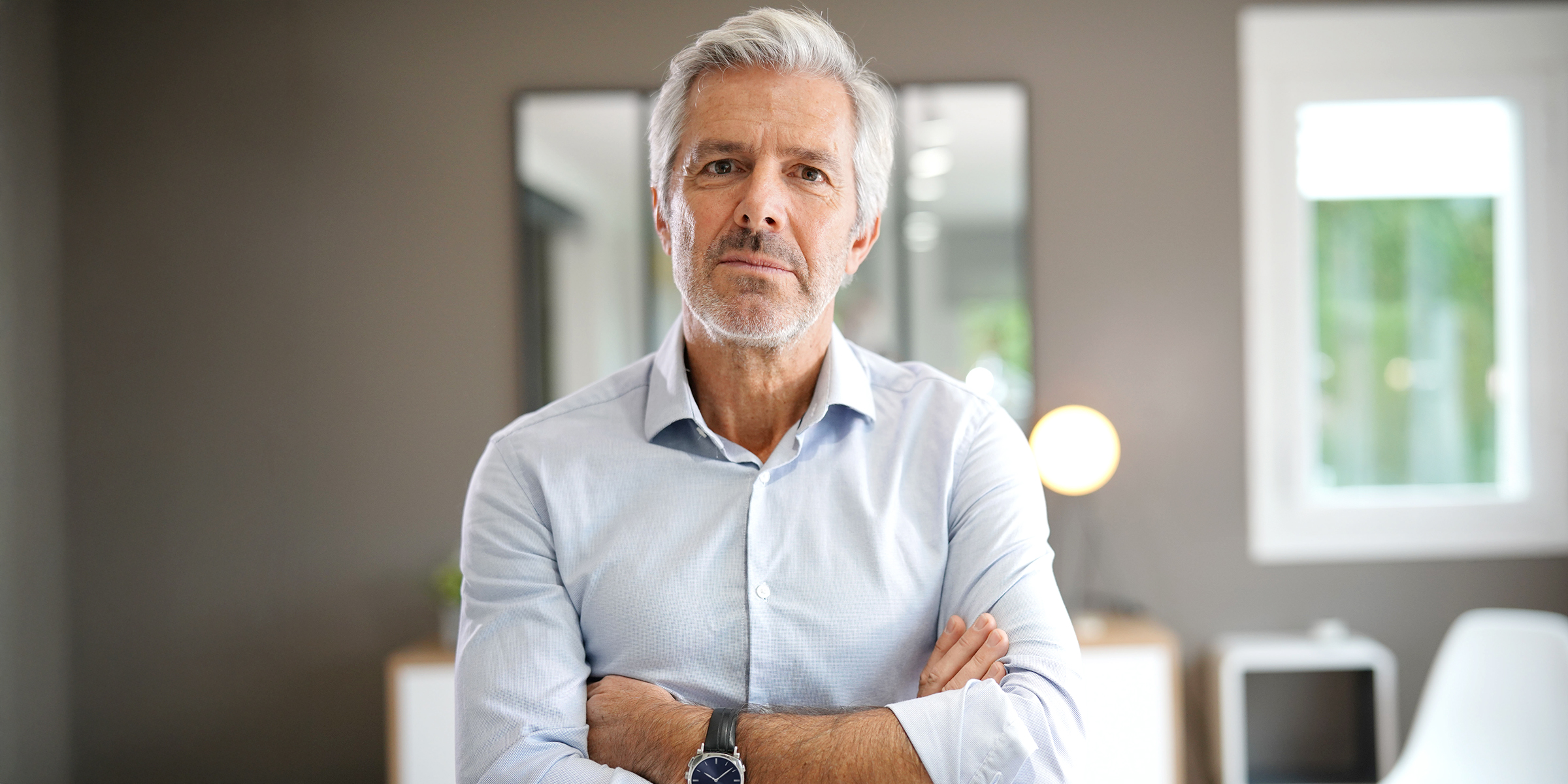 A man standing with his arms crossed | Source: Shutterstock